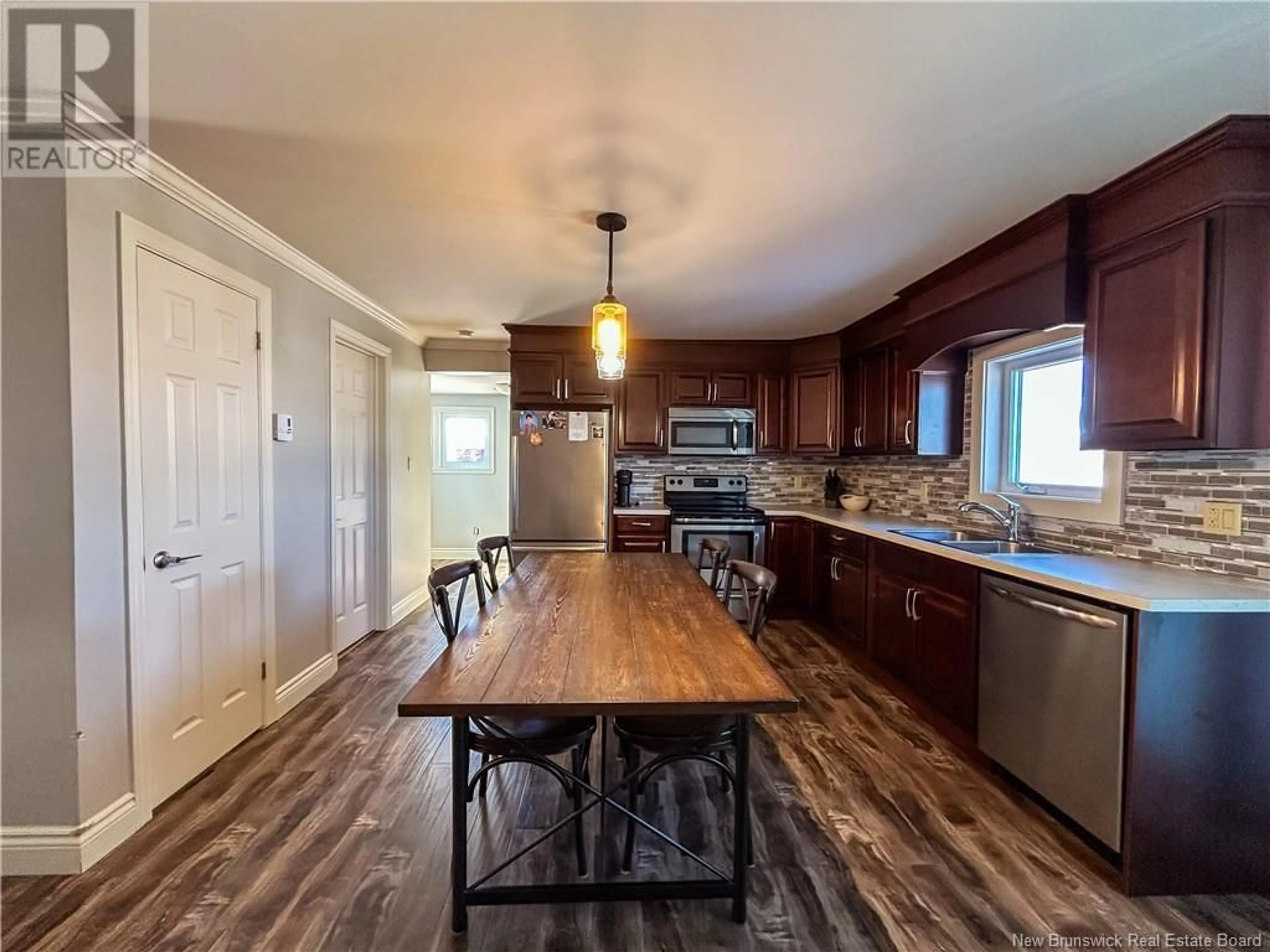 Open concept kitchen, wood/laminate floor for 67 Hillside Street, Campbellton New Brunswick E3N2G1