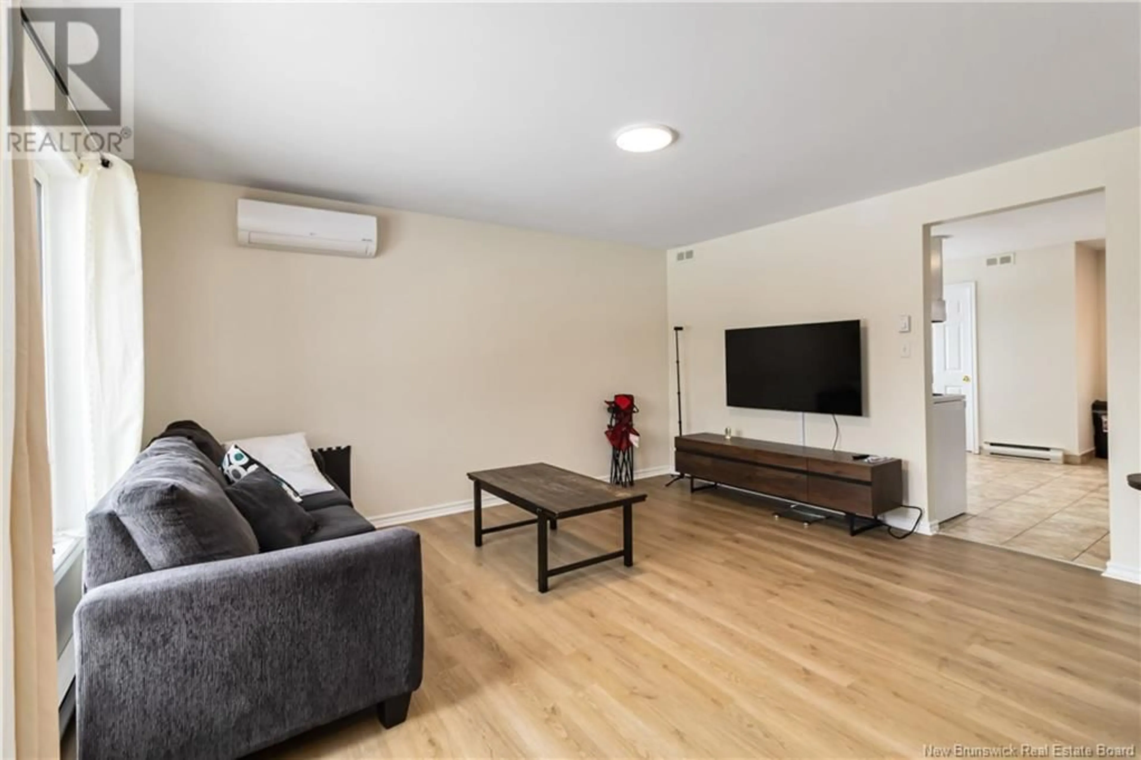 Living room with furniture, wood/laminate floor for 7 Thaddee Street, Dieppe New Brunswick E1A6V4