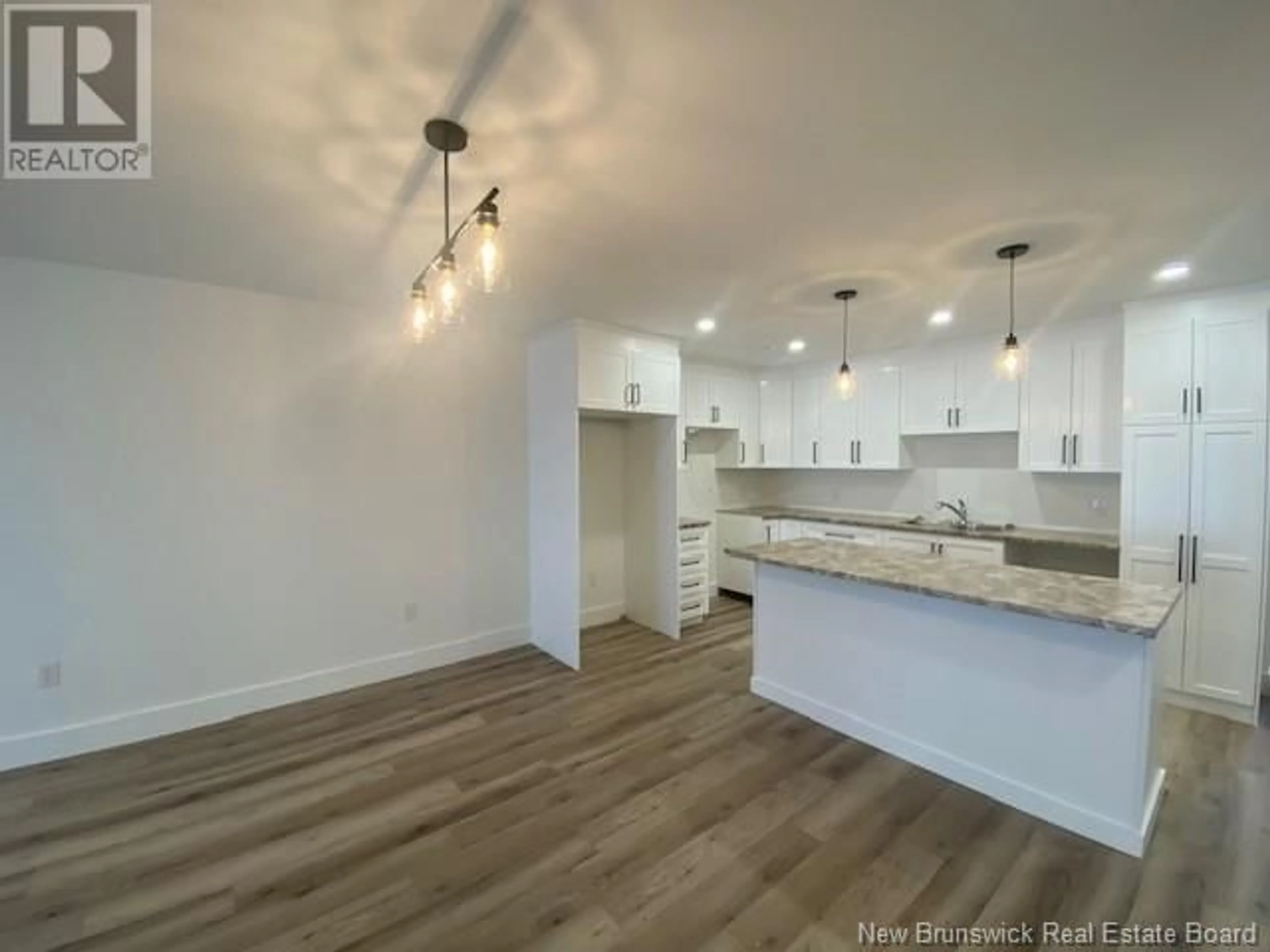 Open concept kitchen, wood/laminate floor for 197 Water Street, Campbellton New Brunswick E3N1B5