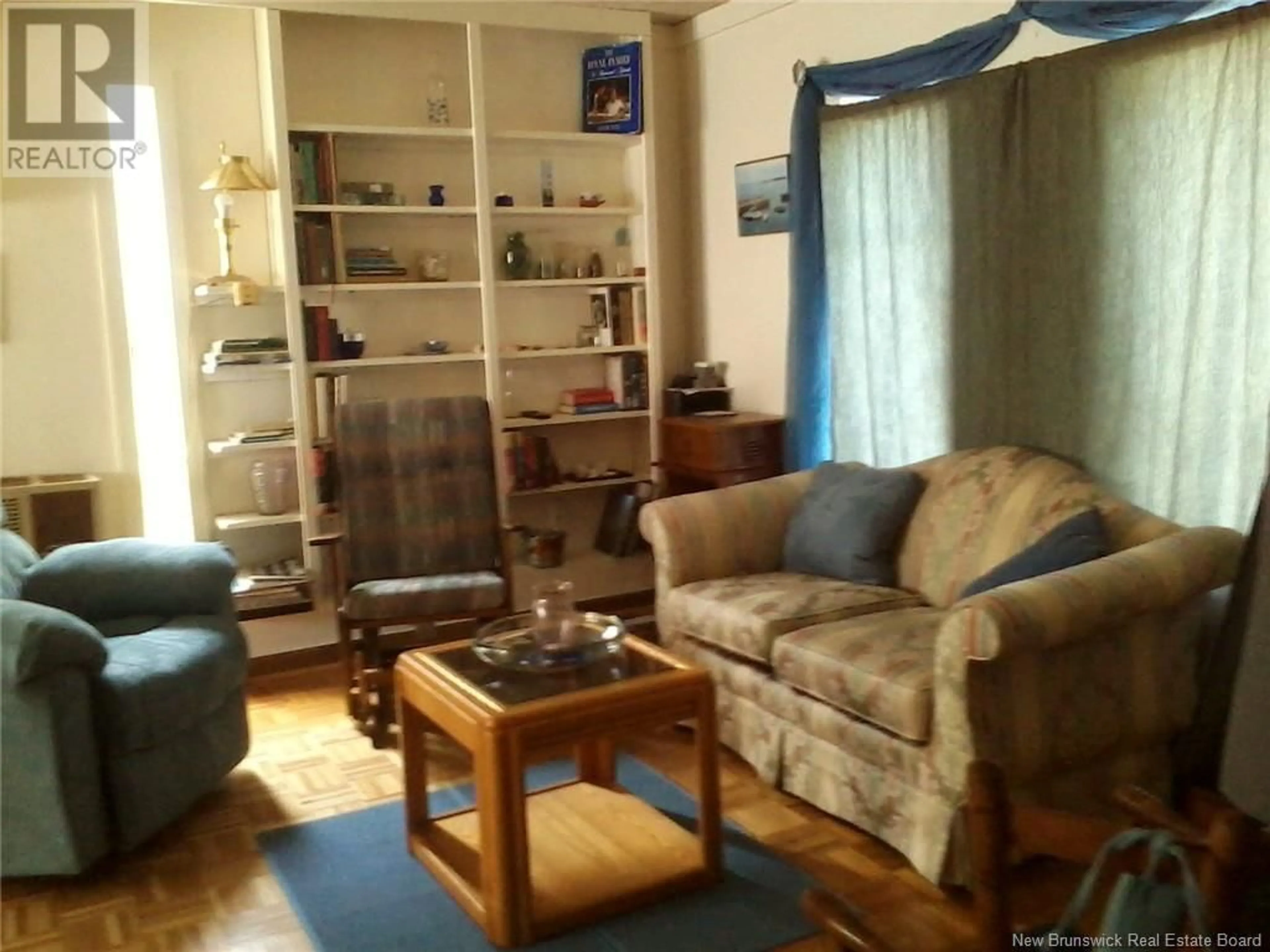 Living room with furniture, wood/laminate floor for 9 Harbour Heights Drive, Welshpool New Brunswick E5E1H8