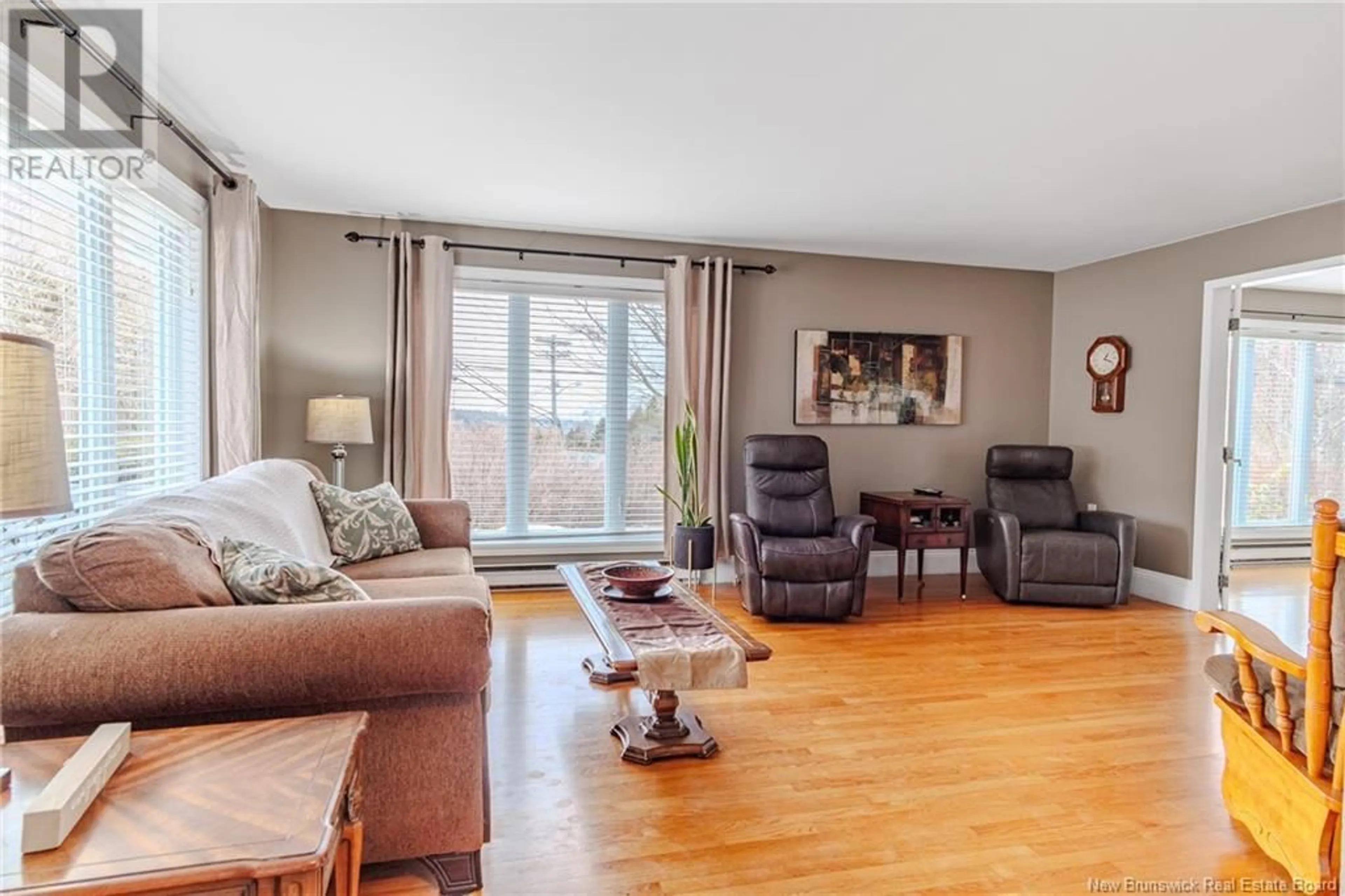 Living room with furniture, wood/laminate floor for 2001 Sandy Point Road, Saint John New Brunswick E2K5H1