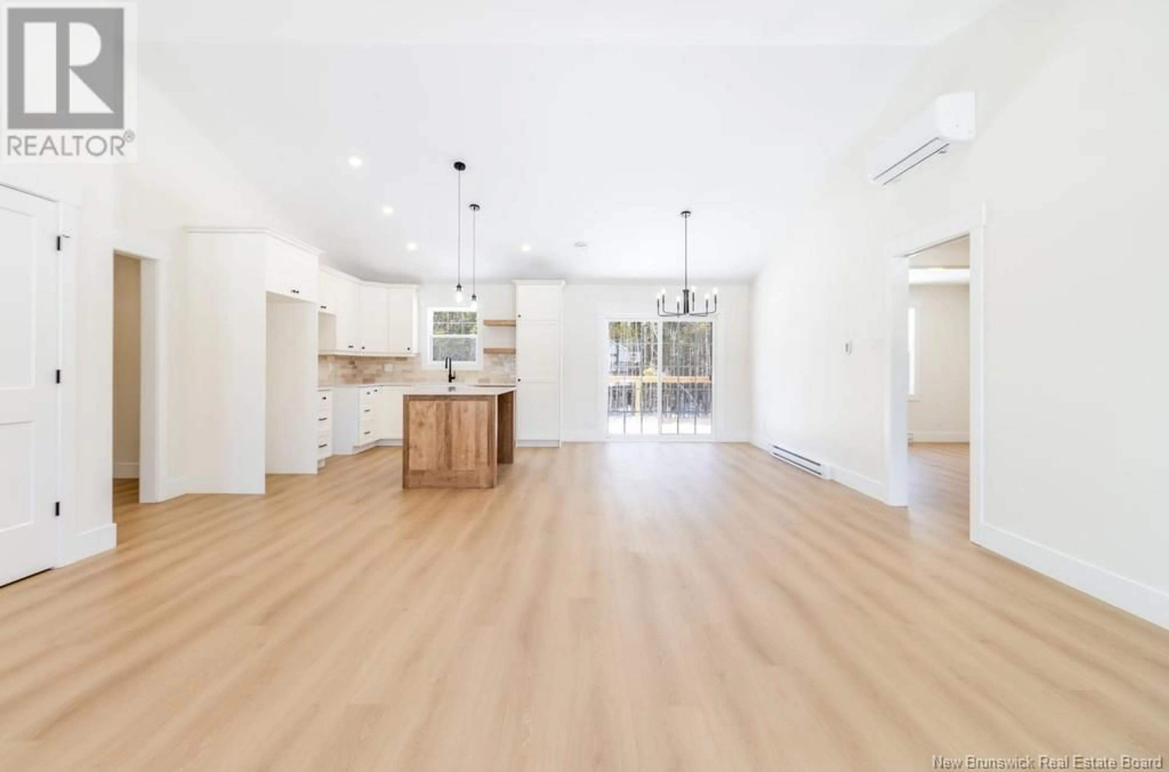 Open concept kitchen, wood/laminate floor for 21 SANDLEWOOD LANE, Douglas New Brunswick E3G0E7