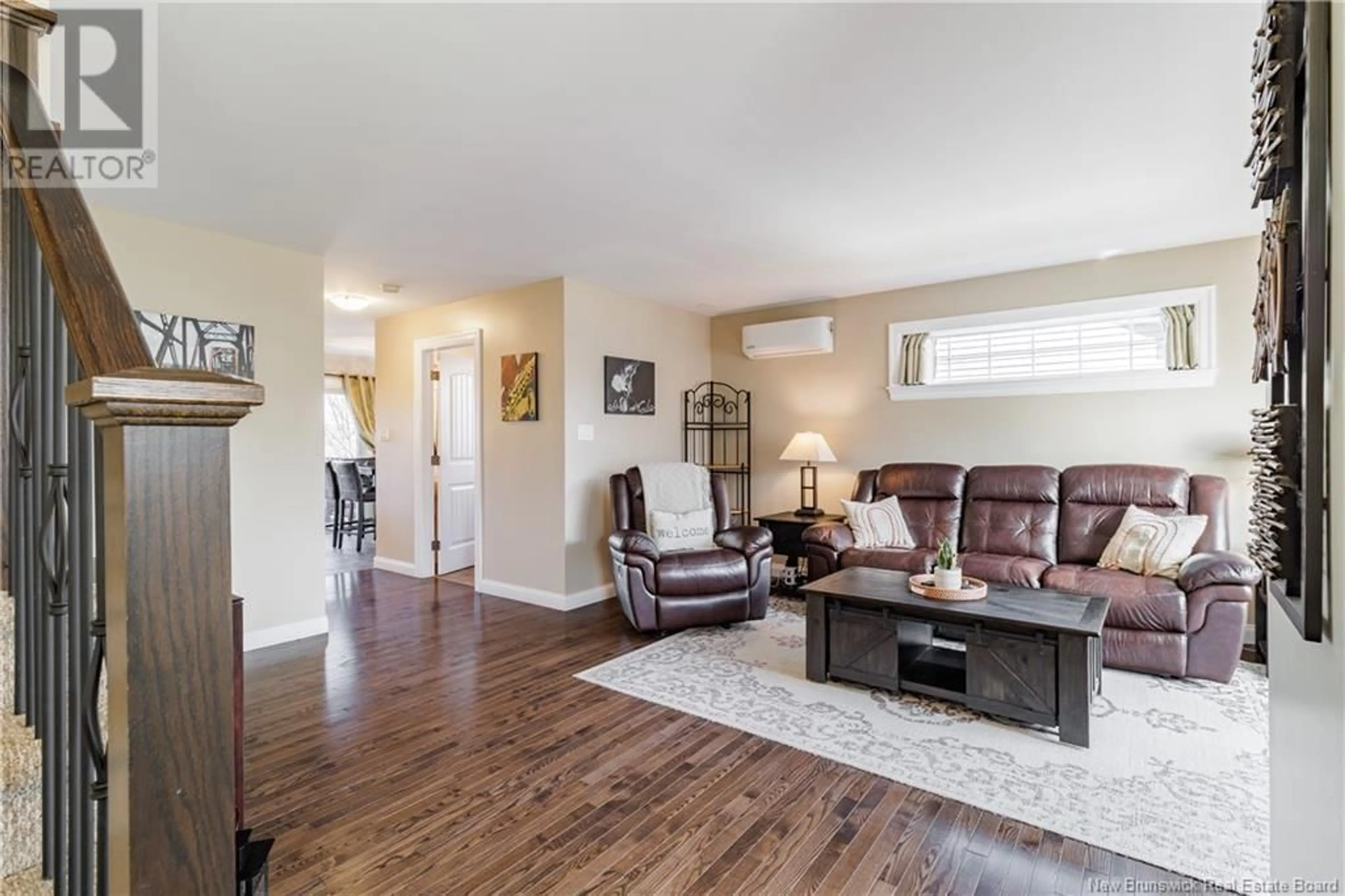 Living room with furniture, wood/laminate floor for 49 COACHMAN DRIVE, Fredericton New Brunswick E3A5W3