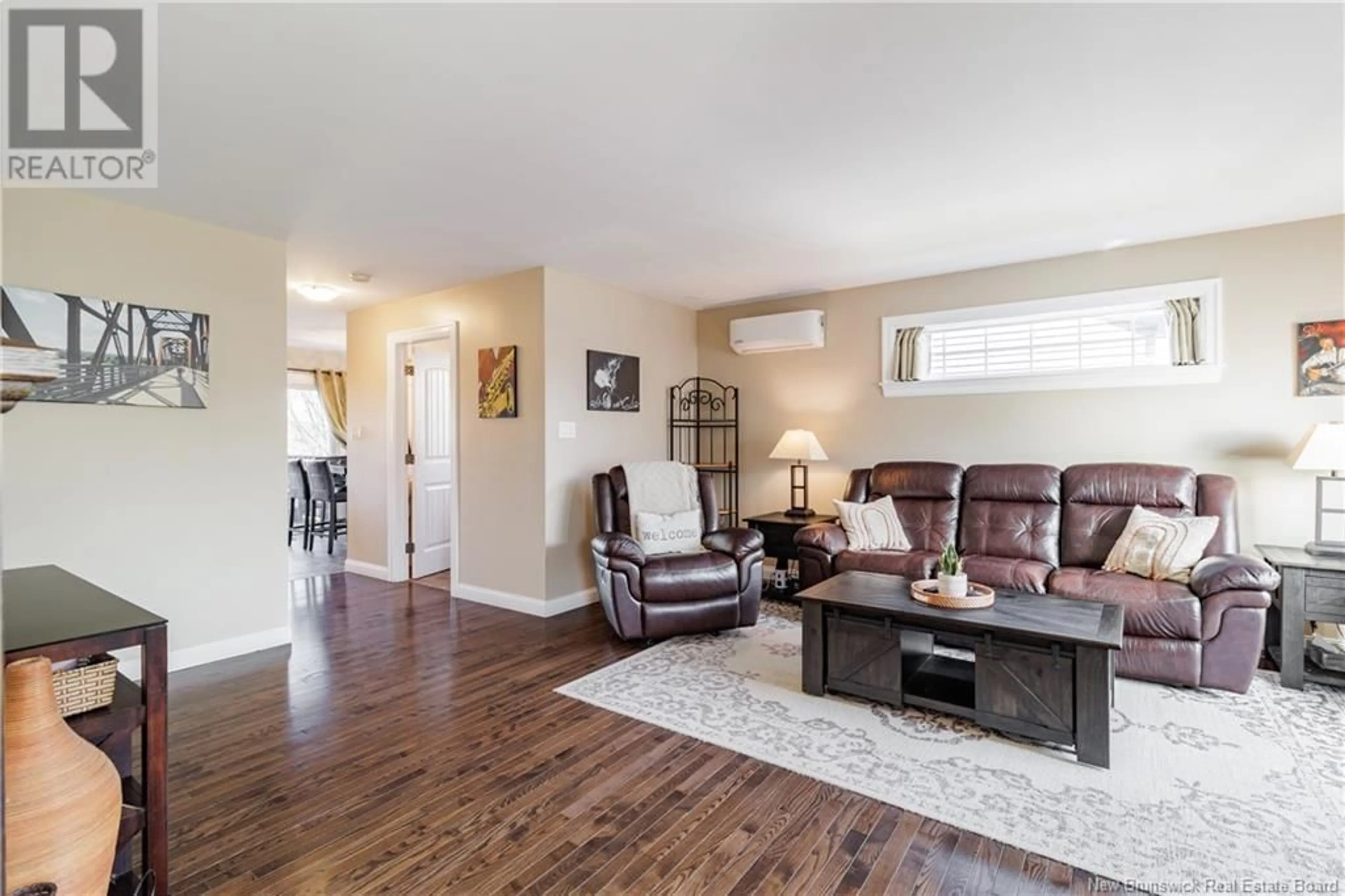 Living room with furniture, wood/laminate floor for 49 COACHMAN DRIVE, Fredericton New Brunswick E3A5W3