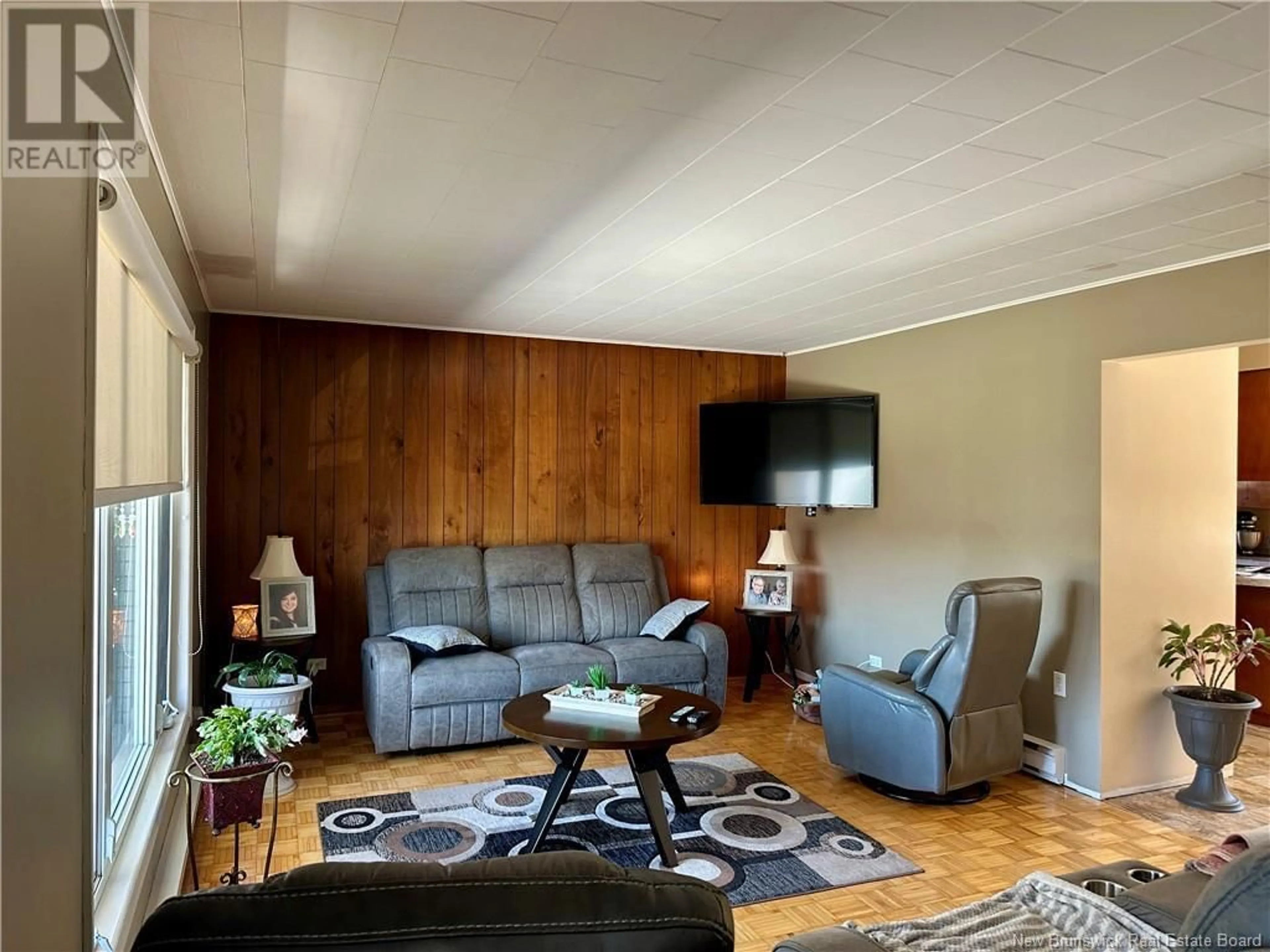 Living room with furniture, wood/laminate floor for 65 32E AVENUE, Edmundston New Brunswick E3V2S1
