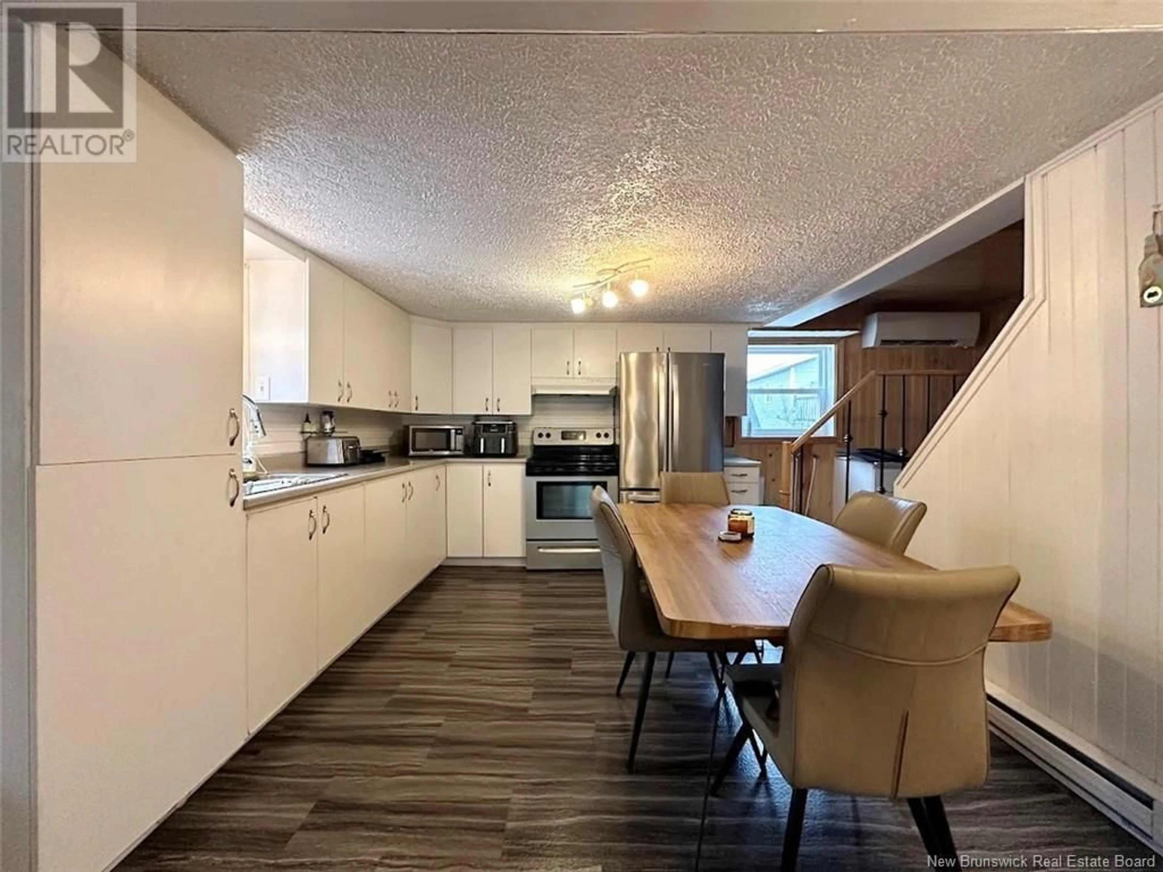 Open concept kitchen, wood/laminate floor for 42 ST-JEAN AVENUE, Edmundston New Brunswick E3V1C8