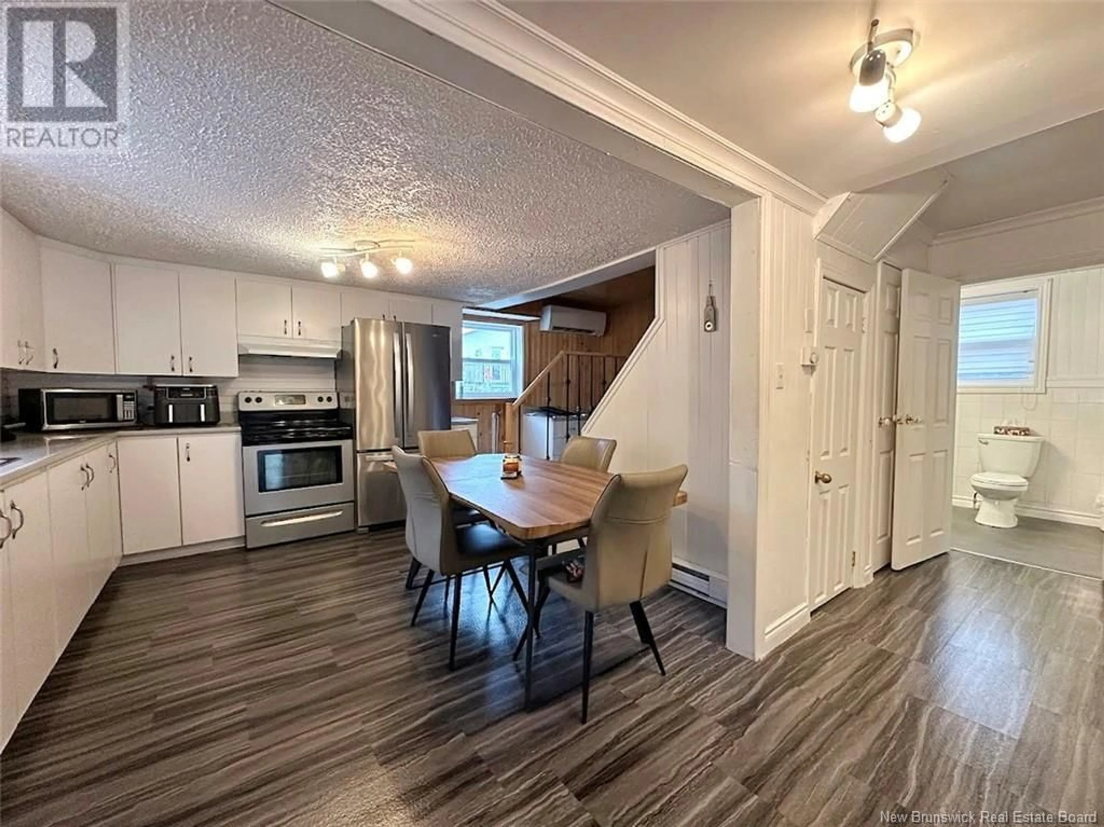 Open concept kitchen, wood/laminate floor for 42 ST-JEAN AVENUE, Edmundston New Brunswick E3V1C8