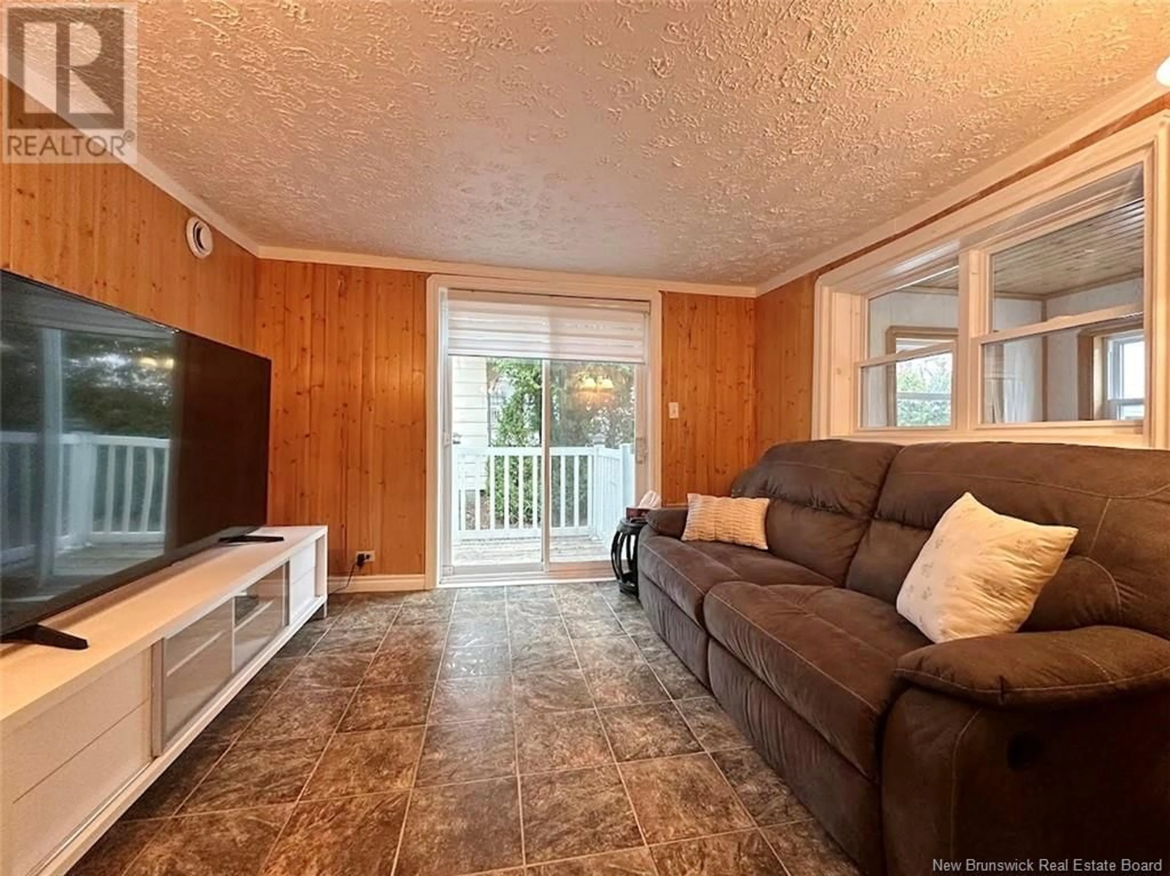 Living room with furniture, wood/laminate floor for 42 ST-JEAN AVENUE, Edmundston New Brunswick E3V1C8