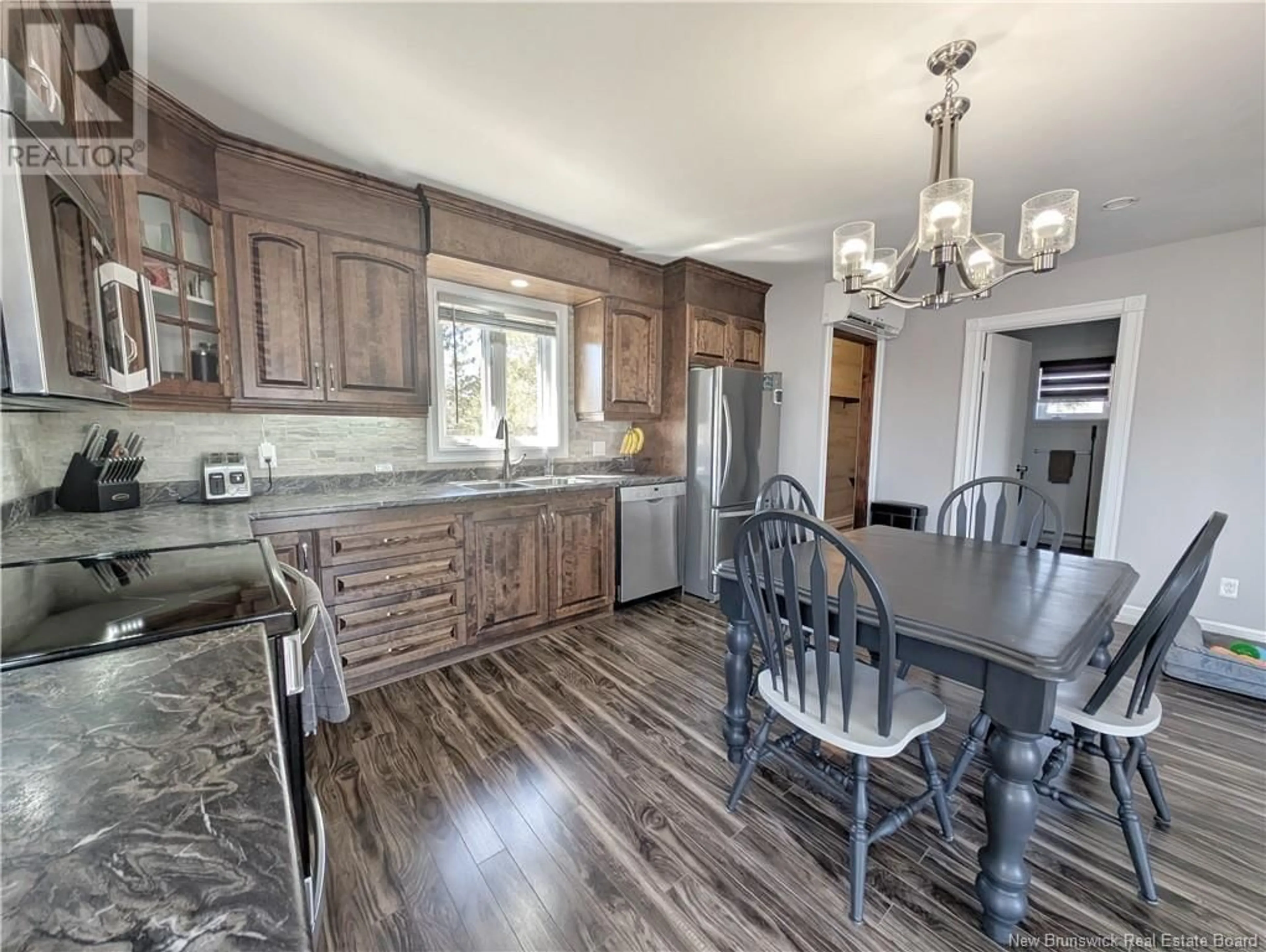 Open concept kitchen, wood/laminate floor for 23 RUE BELLEFEUILLE, Sainte Rose New Brunswick E1X2X8