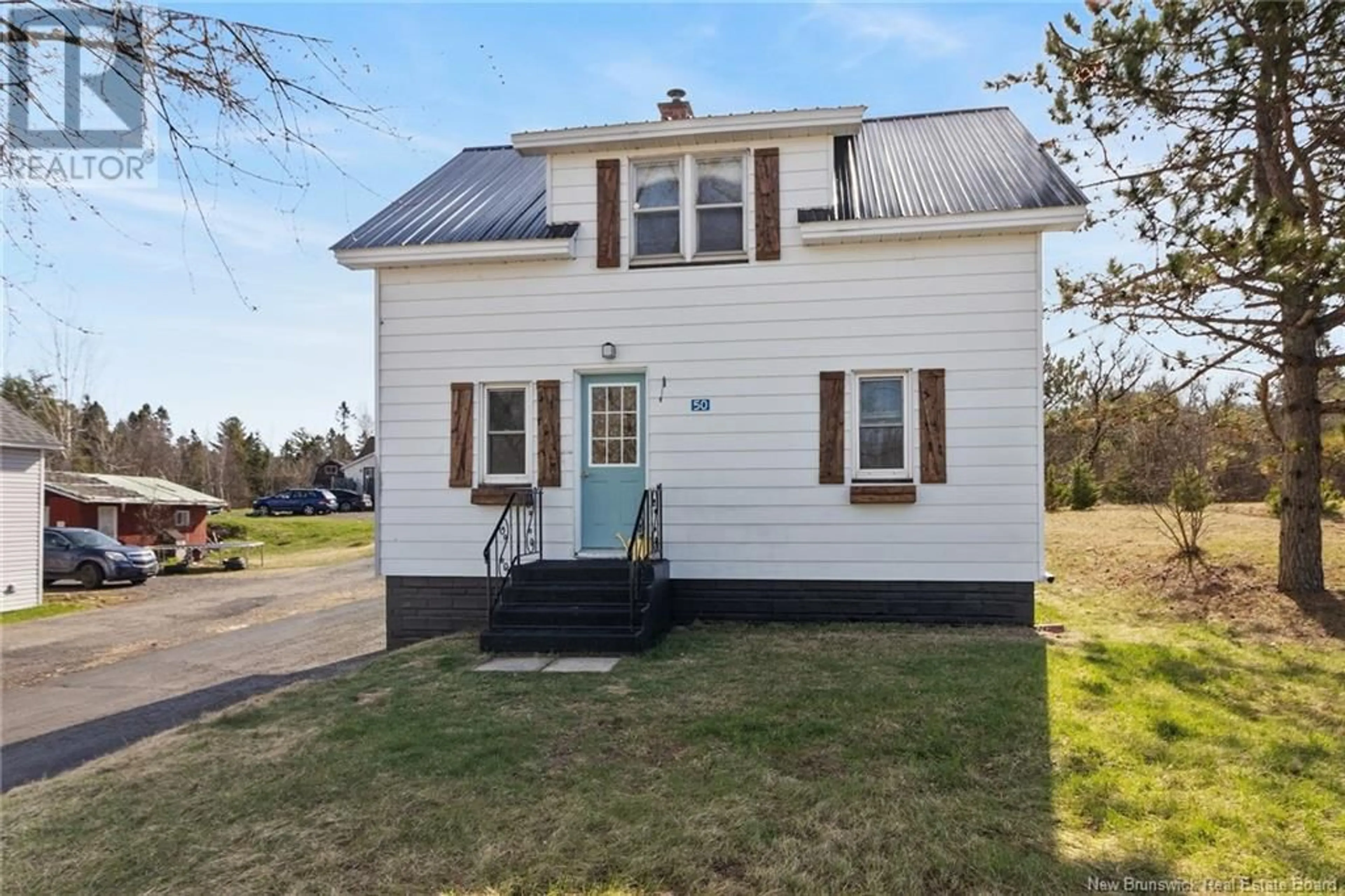 Home with vinyl exterior material, street for 50 MCLEOD AVENUE, Chipman New Brunswick E4A2B8