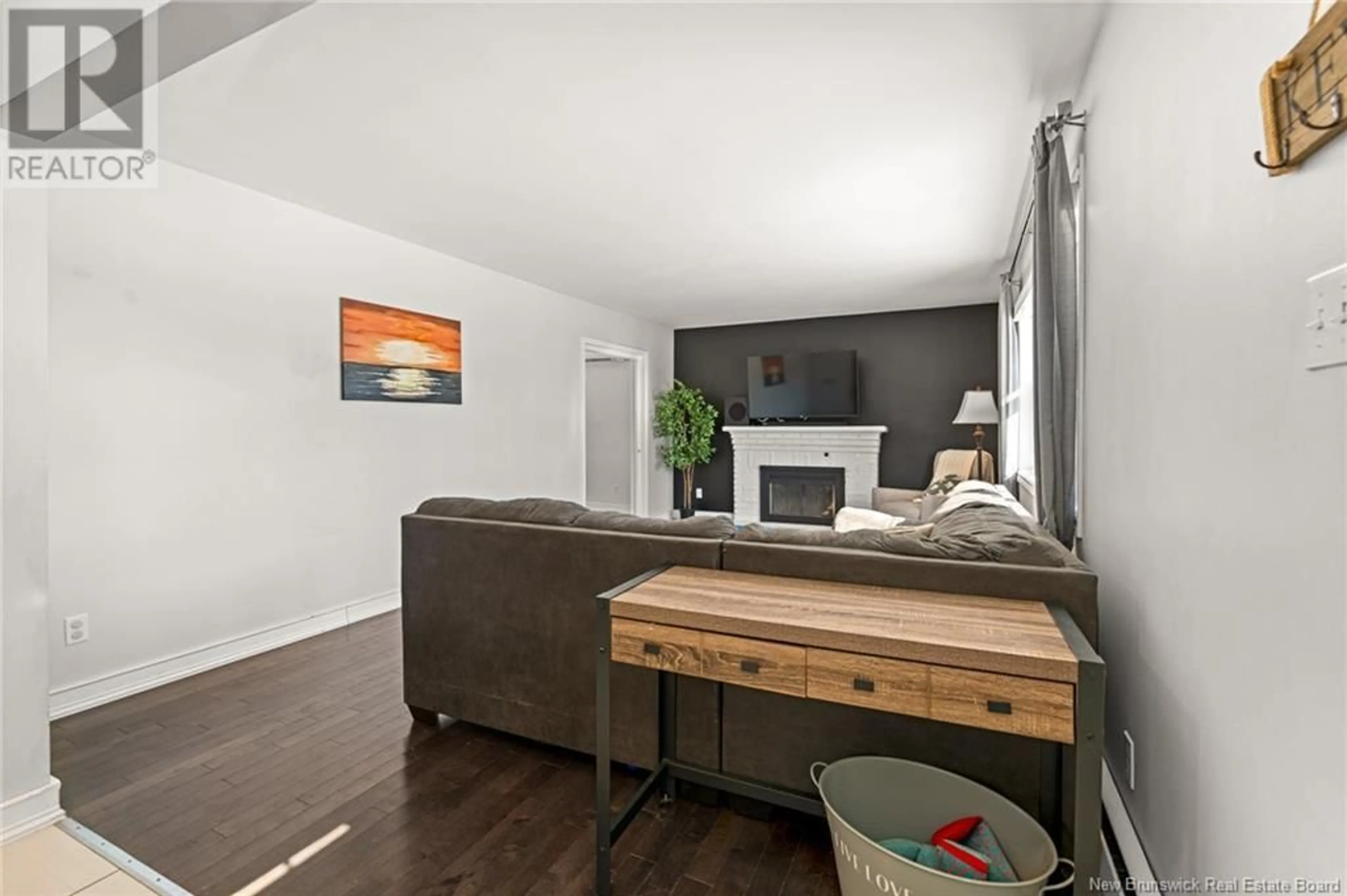 Living room with furniture, wood/laminate floor for 65 MADISON AVENUE, Moncton New Brunswick E1E1R5