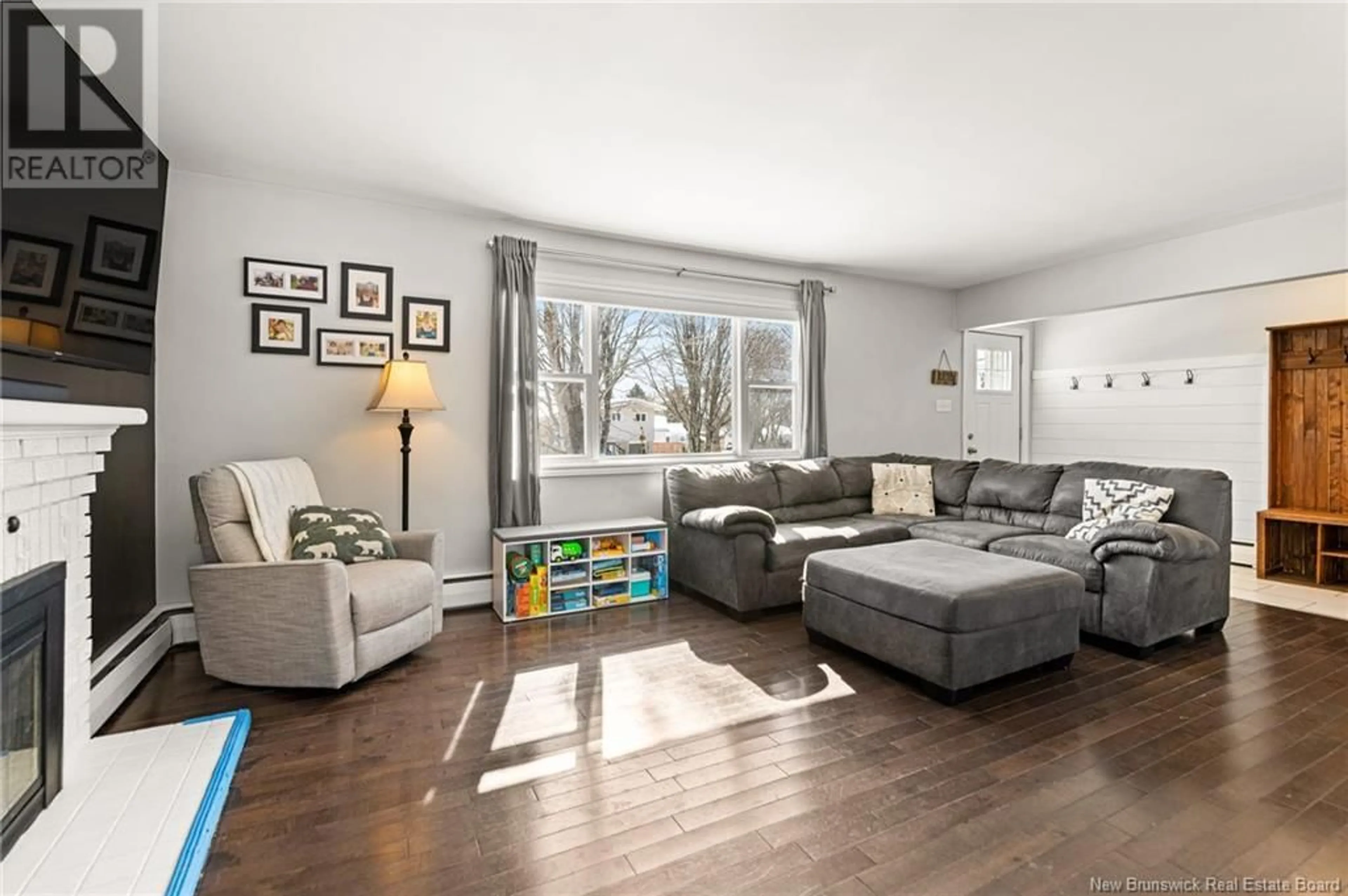 Living room with furniture, wood/laminate floor for 65 MADISON AVENUE, Moncton New Brunswick E1E1R5