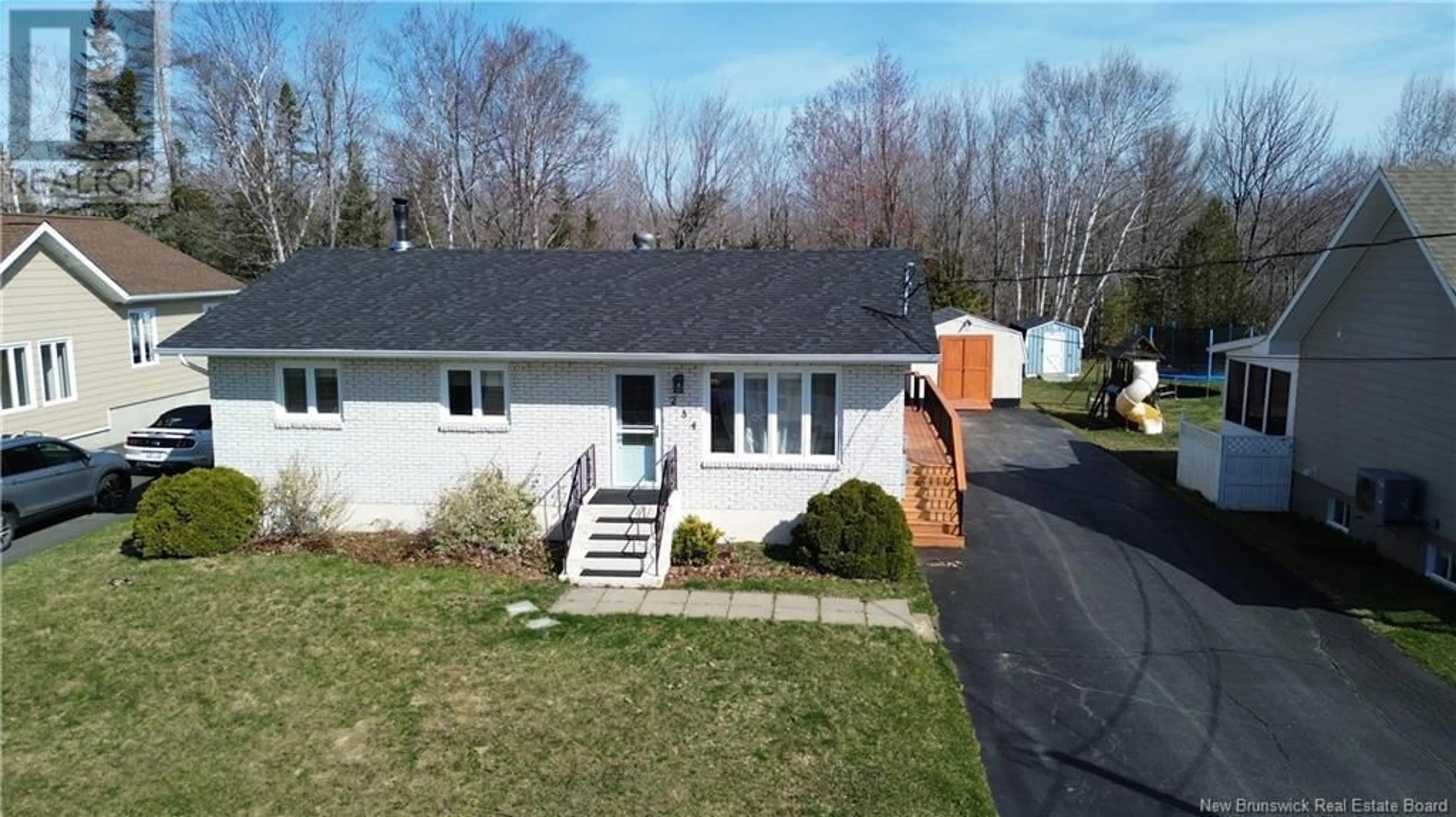 A pic from outside/outdoor area/front of a property/back of a property/a pic from drone, street for 234 LANDRY STREET, Beresford New Brunswick E8K1H1