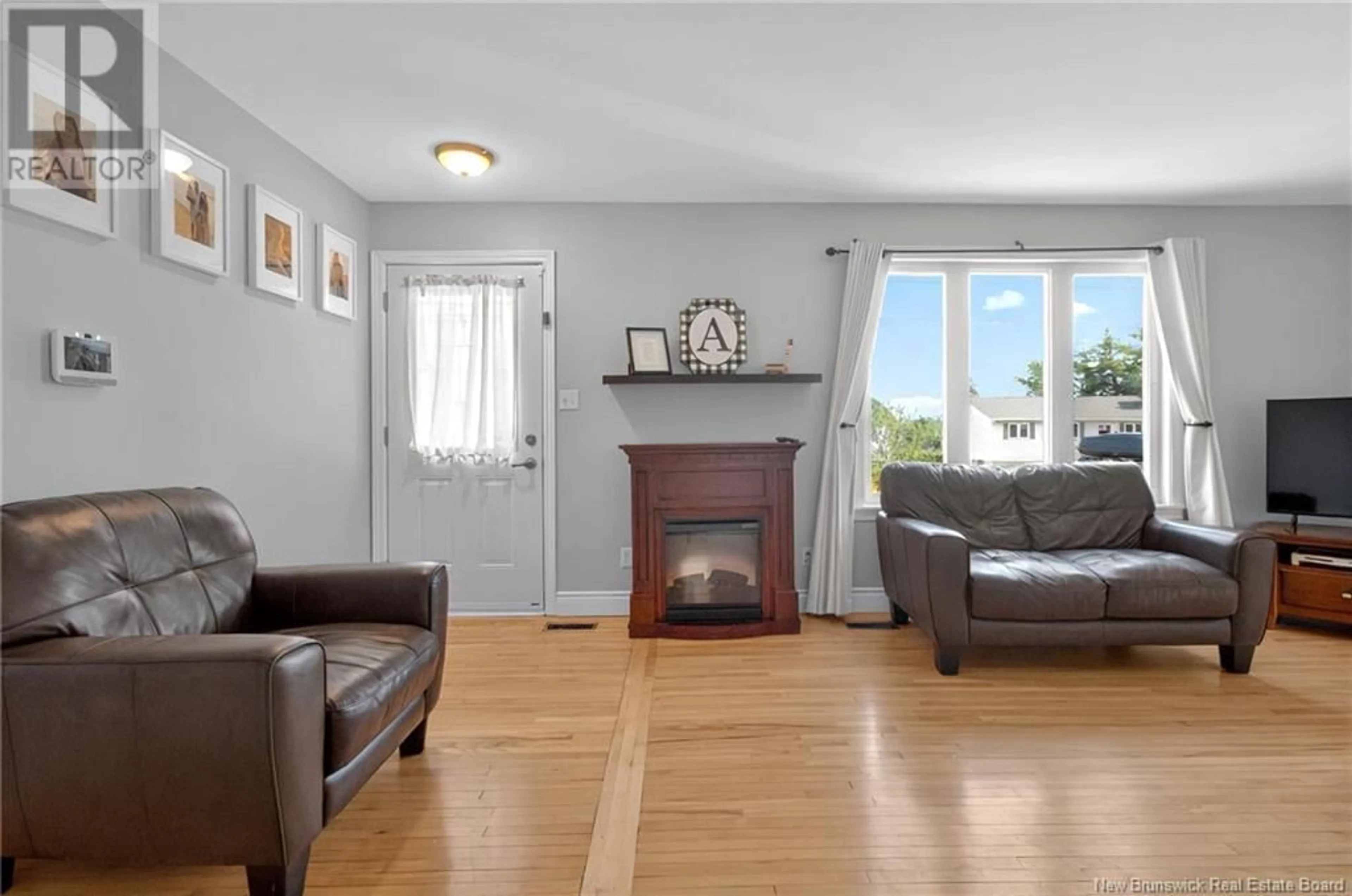 Living room with furniture, wood/laminate floor for 15 GREENHILL DRIVE, Moncton New Brunswick E1A2L6