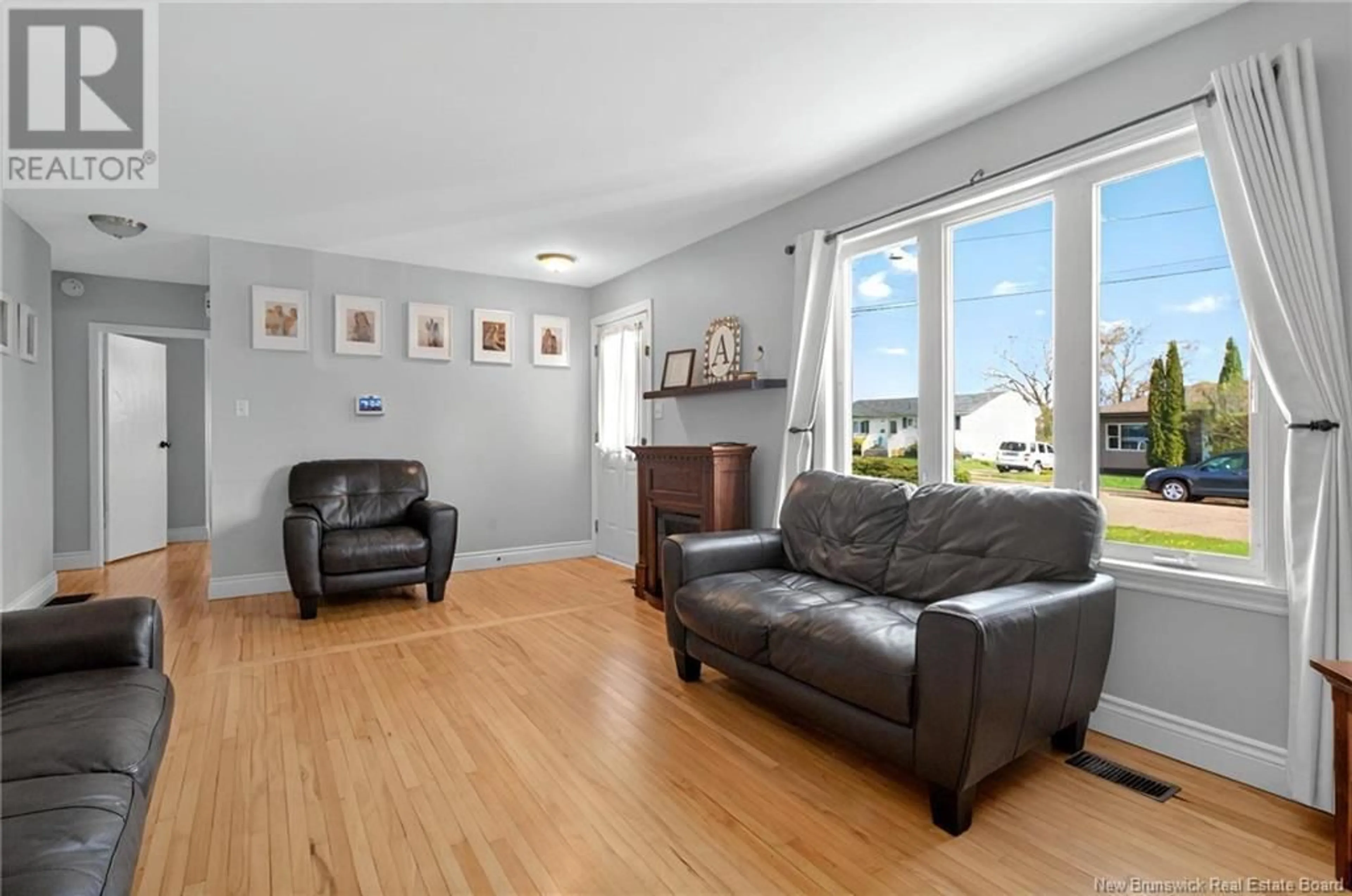 Living room with furniture, wood/laminate floor for 15 GREENHILL DRIVE, Moncton New Brunswick E1A2L6