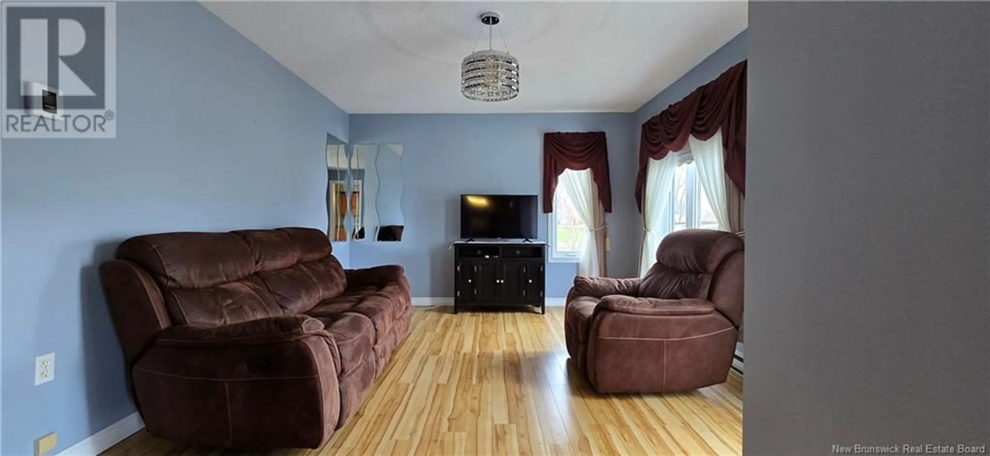 Living room with furniture, wood/laminate floor for 5483 ROUTE 11, Brantville New Brunswick E9H2A8