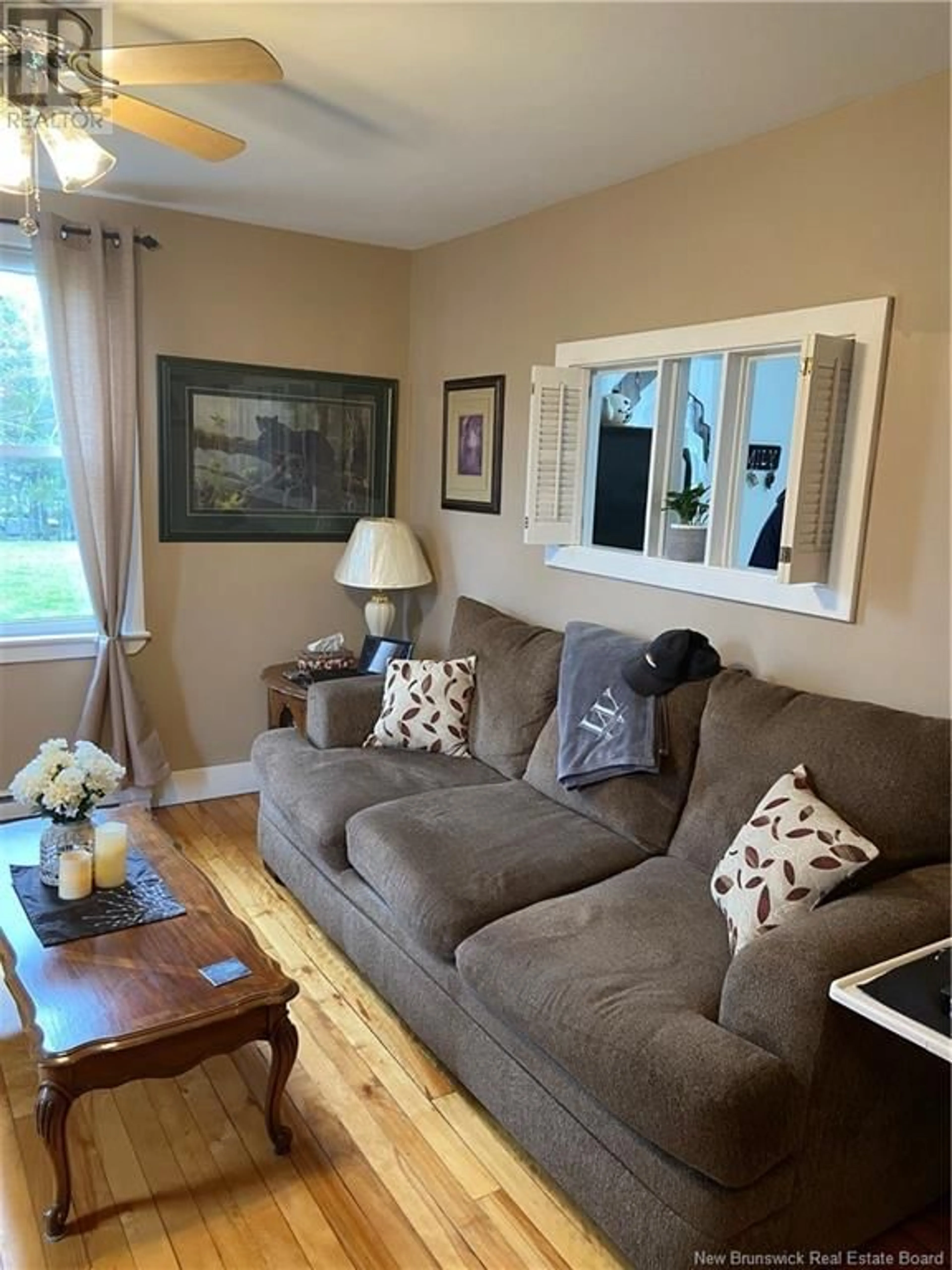 Living room with furniture, wood/laminate floor for 11 LILA COURT, Quispamsis New Brunswick E2E3R5