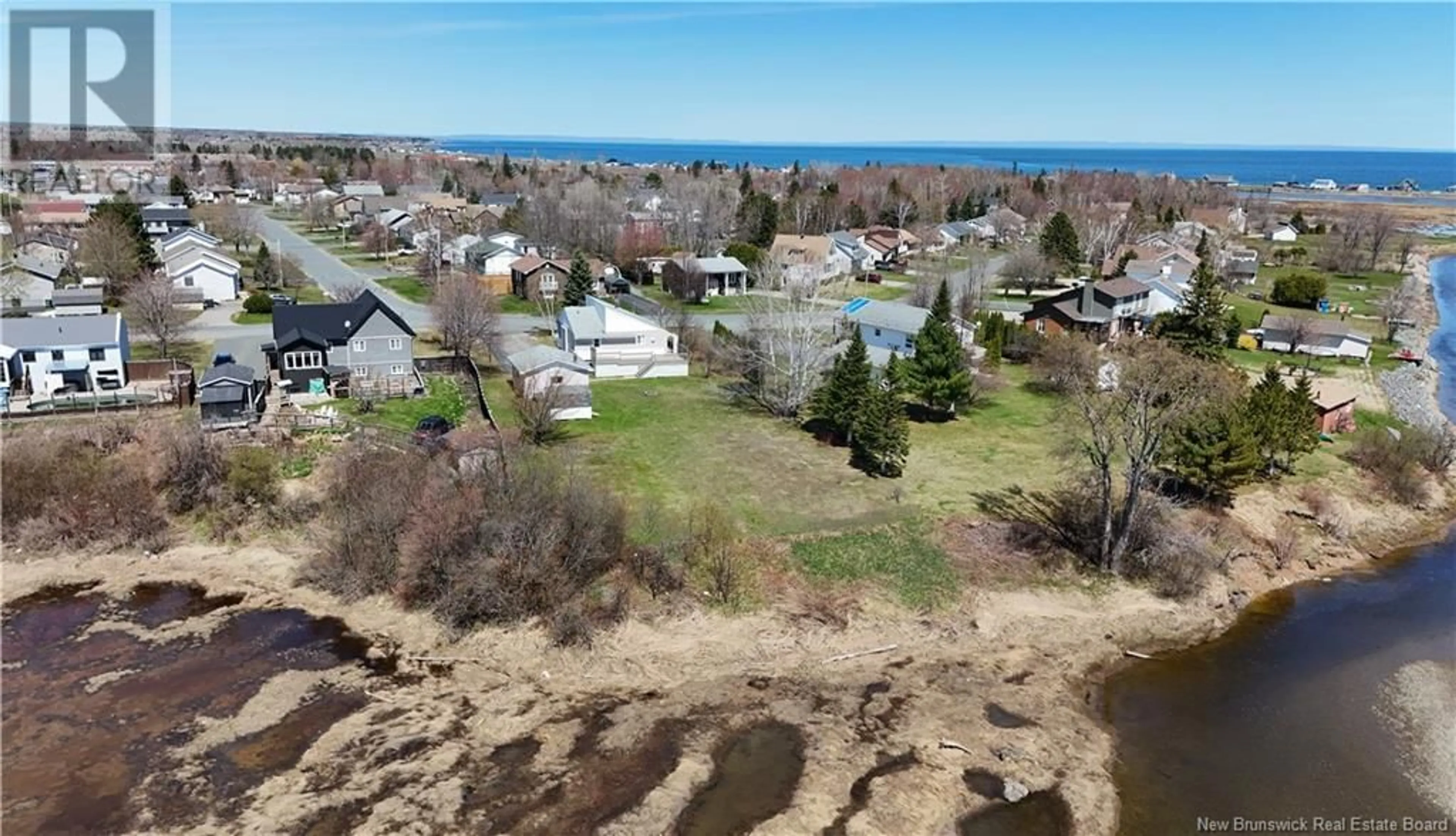 A pic from outside/outdoor area/front of a property/back of a property/a pic from drone, water/lake/river/ocean view for 784 ST PIERRE, Beresford New Brunswick E8K1S1