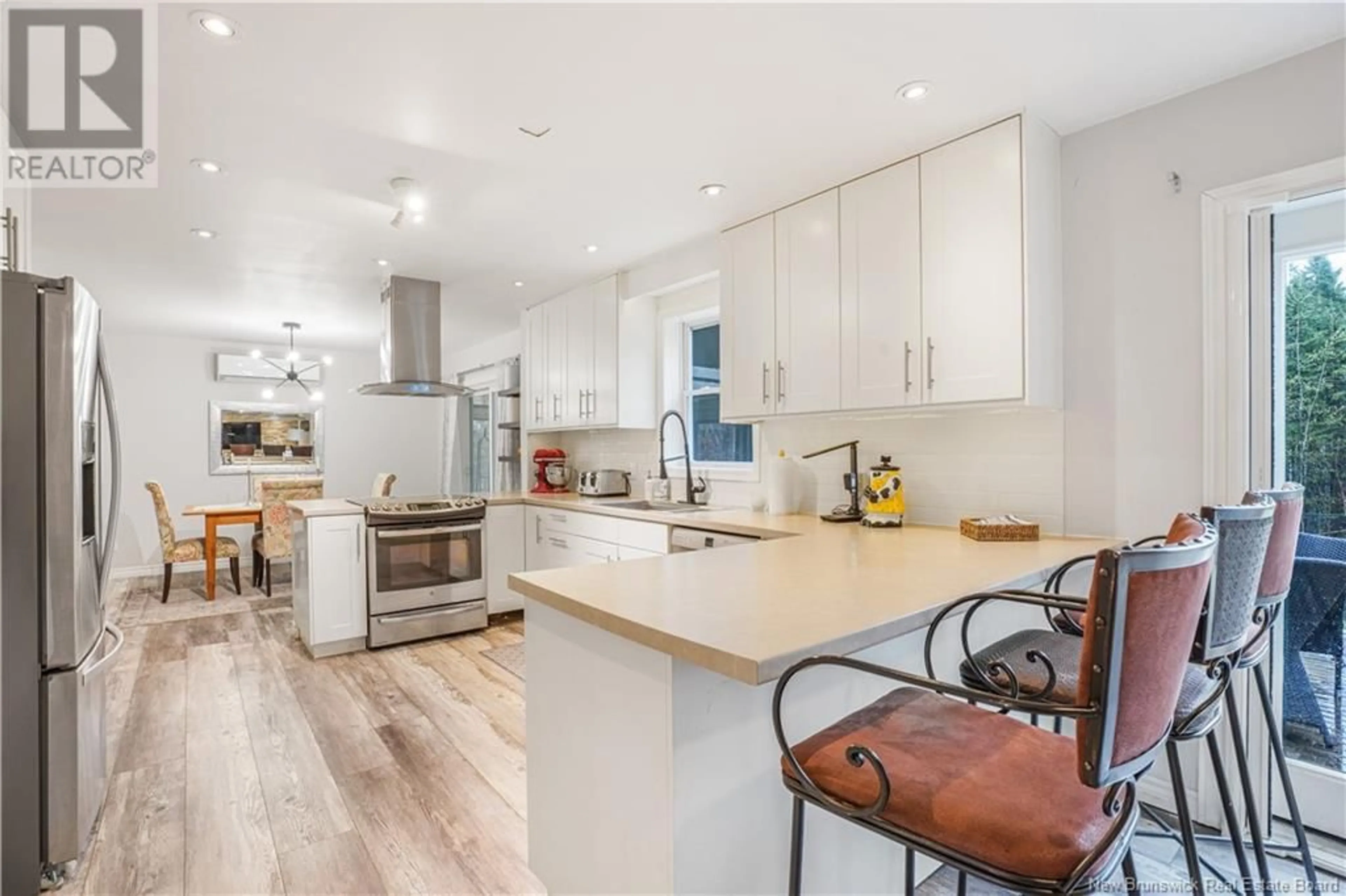 Open concept kitchen, wood/laminate floor for 122 BURNETT DRIVE, Hanwell New Brunswick E3C2J4
