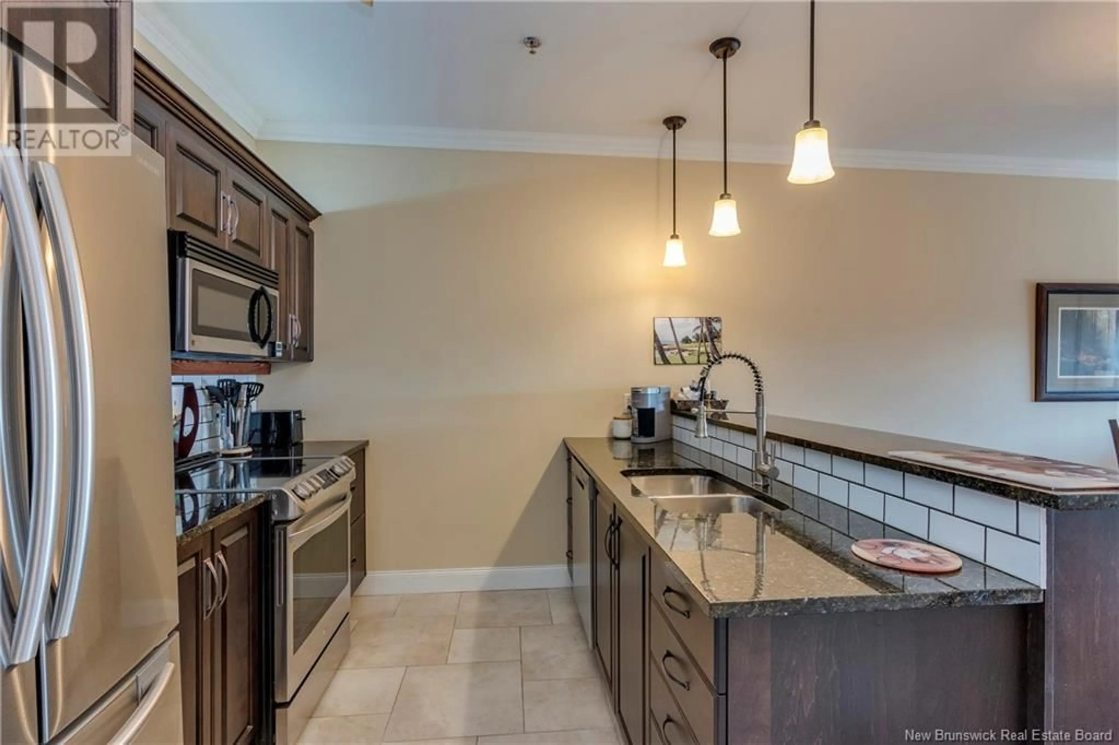 Open concept kitchen, ceramic/tile floor for 207 - 88 WOODS TERRACE, Moncton New Brunswick E1G1X6
