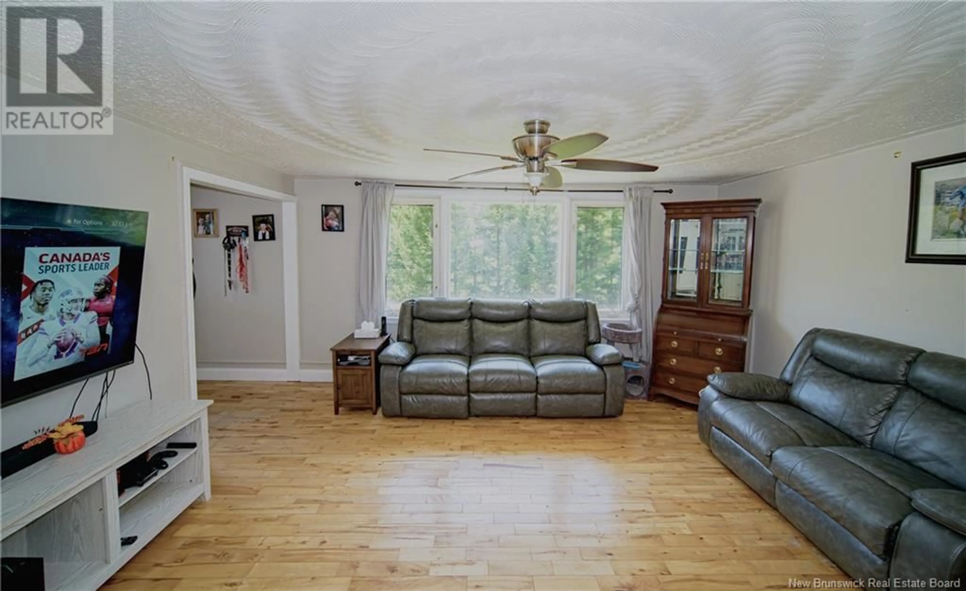 Living room with furniture, wood/laminate floor for 95 MCMINNIMAN COURT, Fredericton New Brunswick E3A8S5