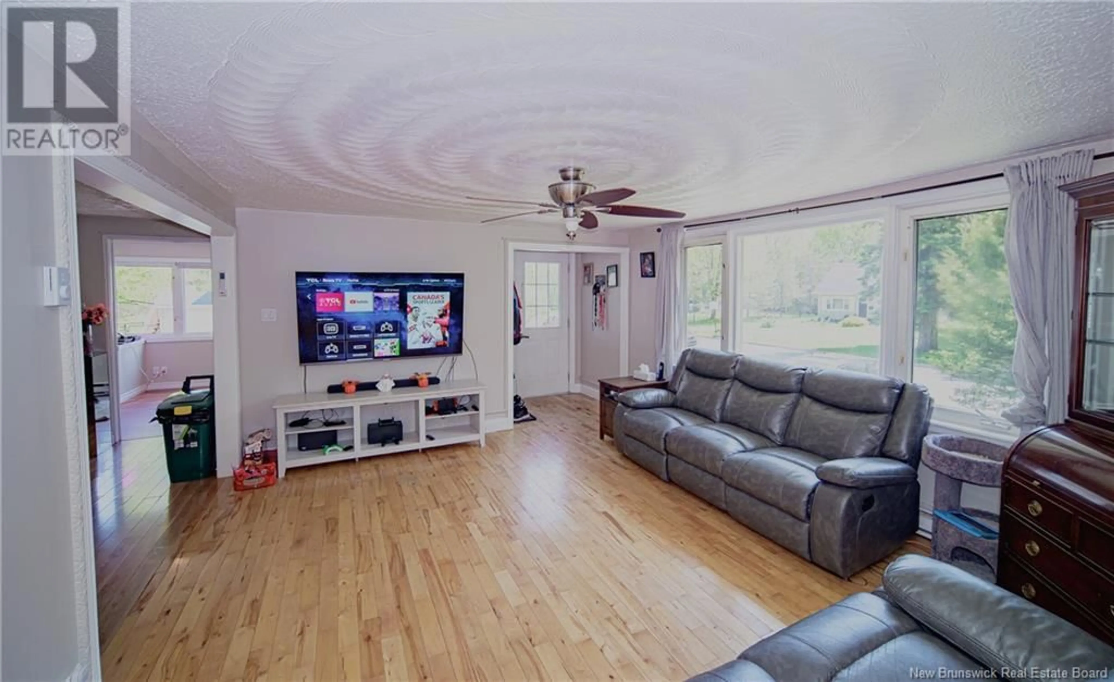 Living room with furniture, wood/laminate floor for 95 MCMINNIMAN COURT, Fredericton New Brunswick E3A8S5