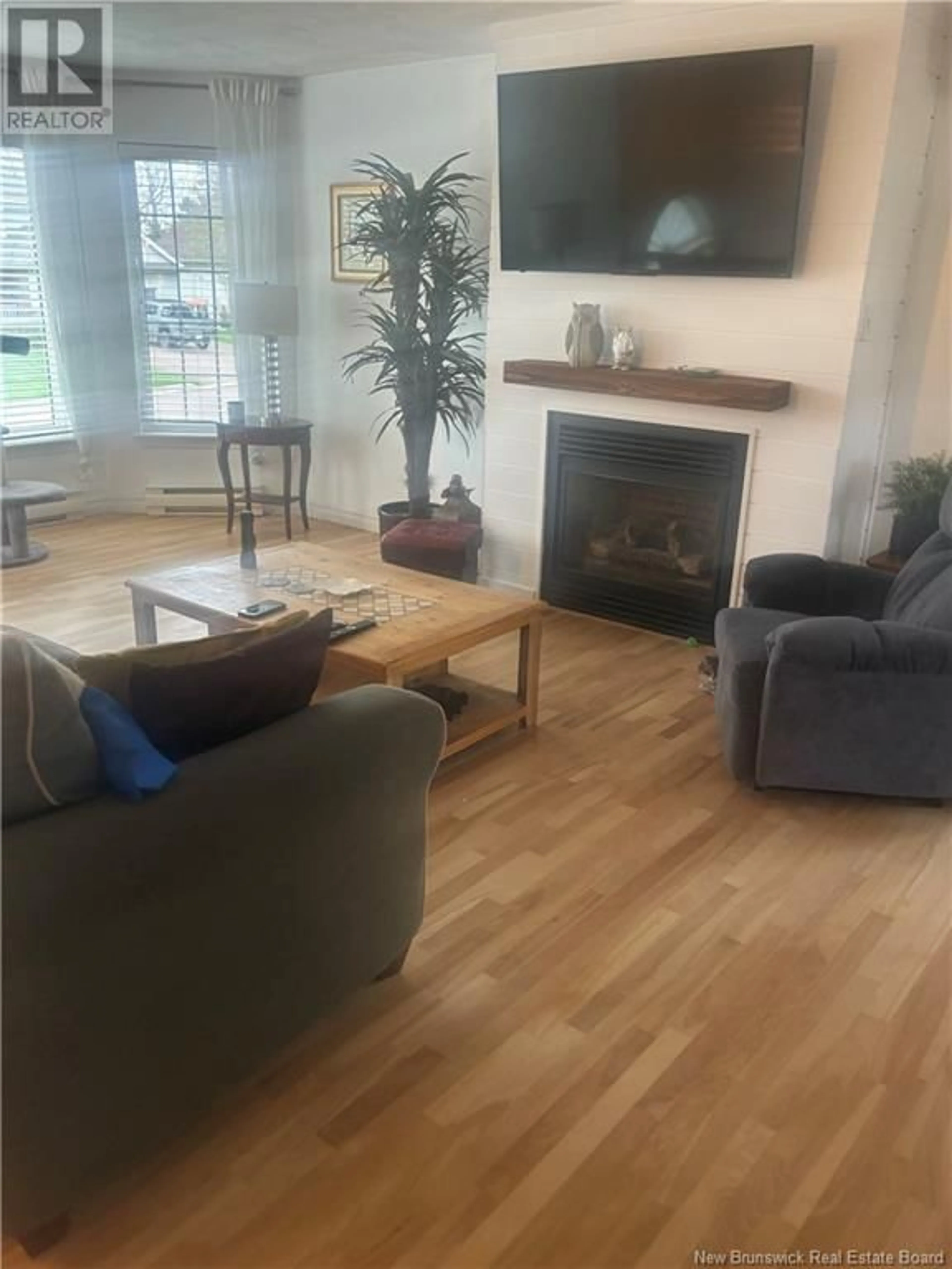 Living room with furniture, wood/laminate floor for 11 FOXWOOD DRIVE, Moncton New Brunswick E1G3S6