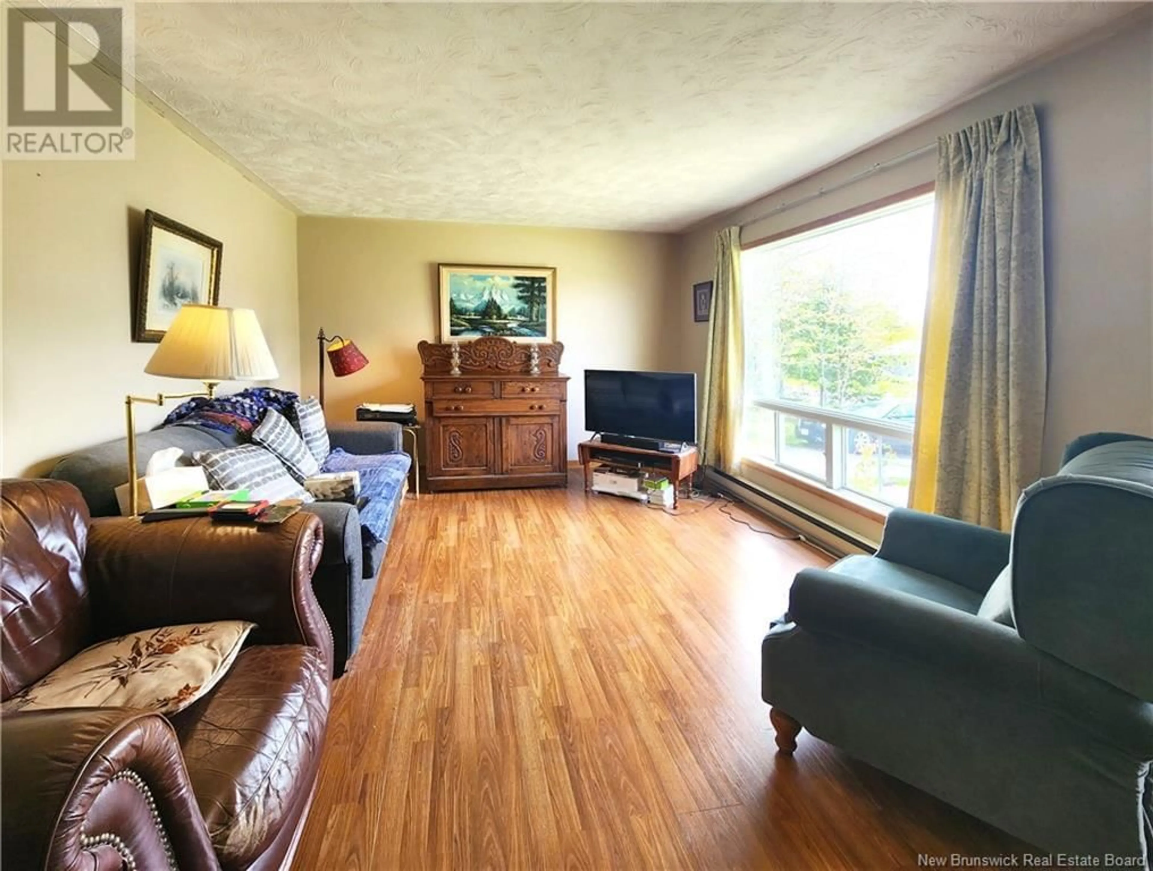 Living room with furniture, wood/laminate floor for 19 KENNETH DRIVE, Quispamsis New Brunswick E2G1H9