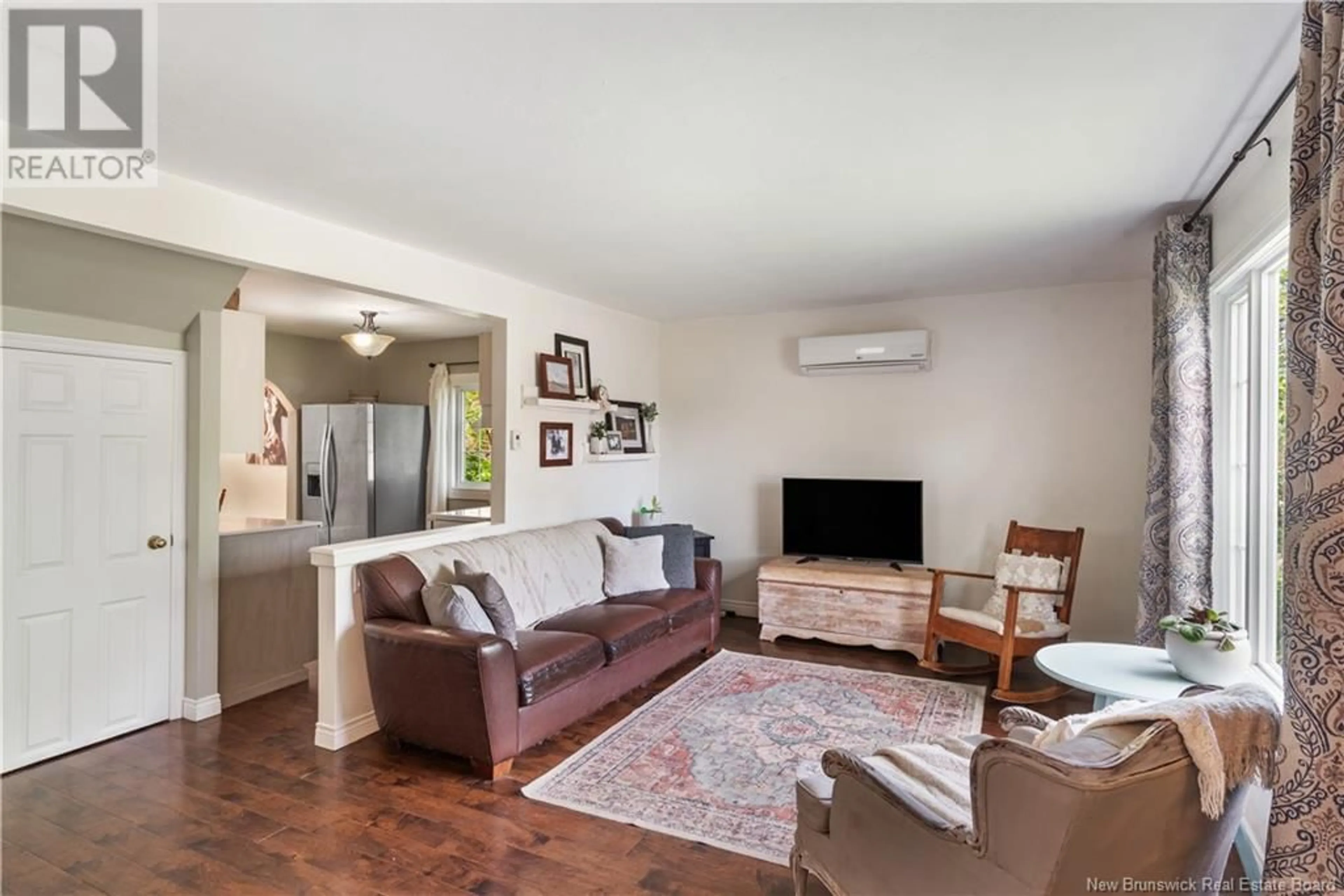 Living room with furniture, wood/laminate floor for 134 LESLIE STREET, Moncton New Brunswick E1C6M5