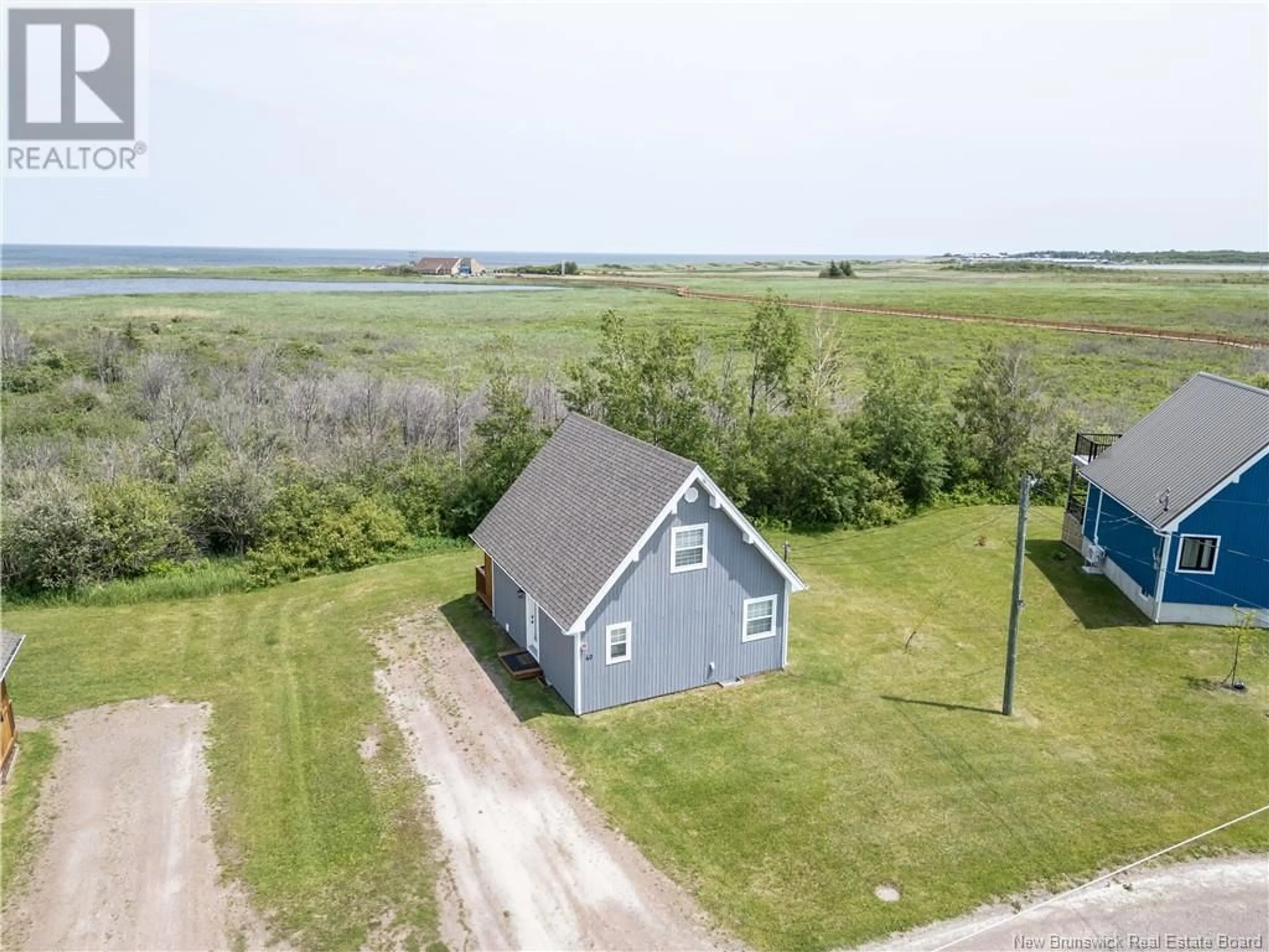 A pic from outside/outdoor area/front of a property/back of a property/a pic from drone, water/lake/river/ocean view for 40 ALLEE DU PARC, Cap-Pelé New Brunswick E4N1S4