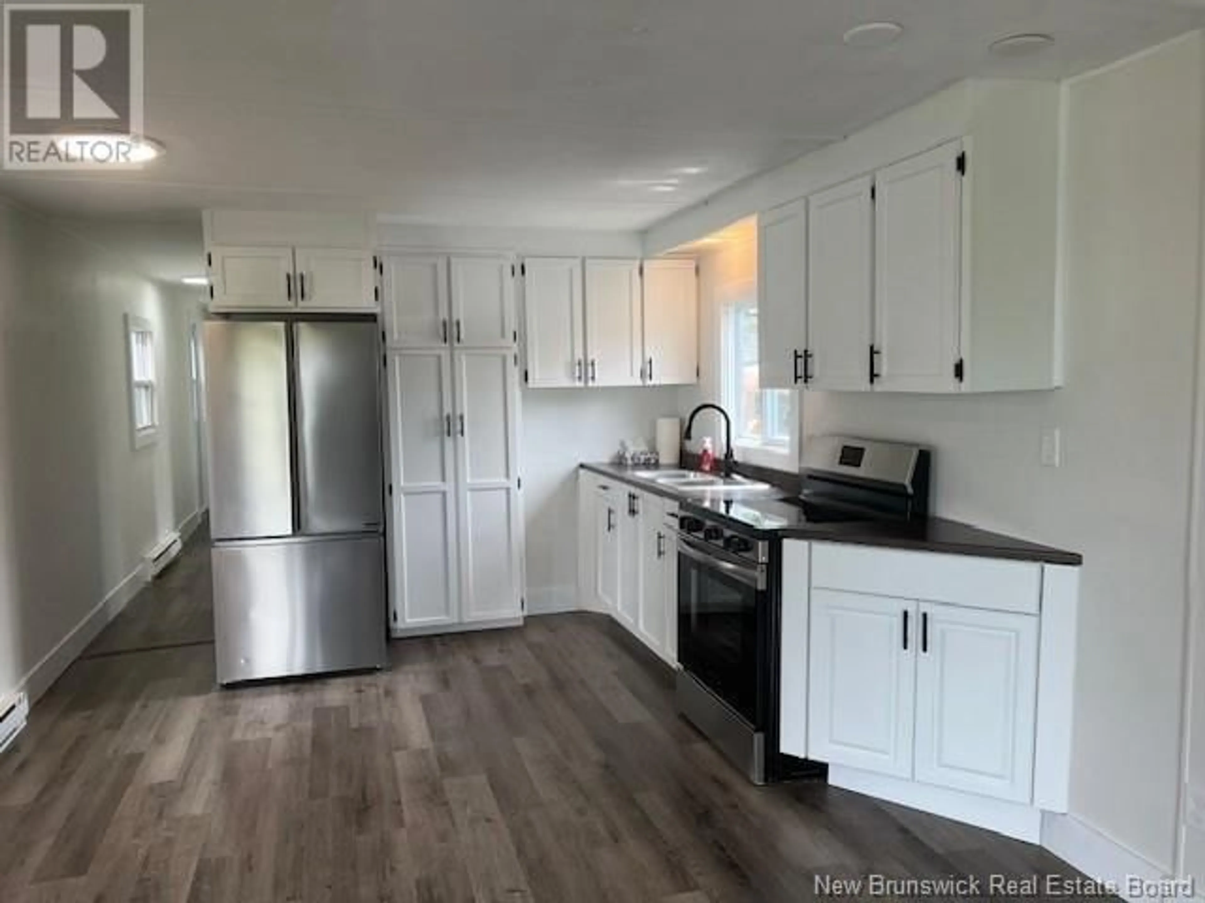 Open concept kitchen, wood/laminate floor for 132 TAMARACK LANE, Quispamsis New Brunswick E2G1T7