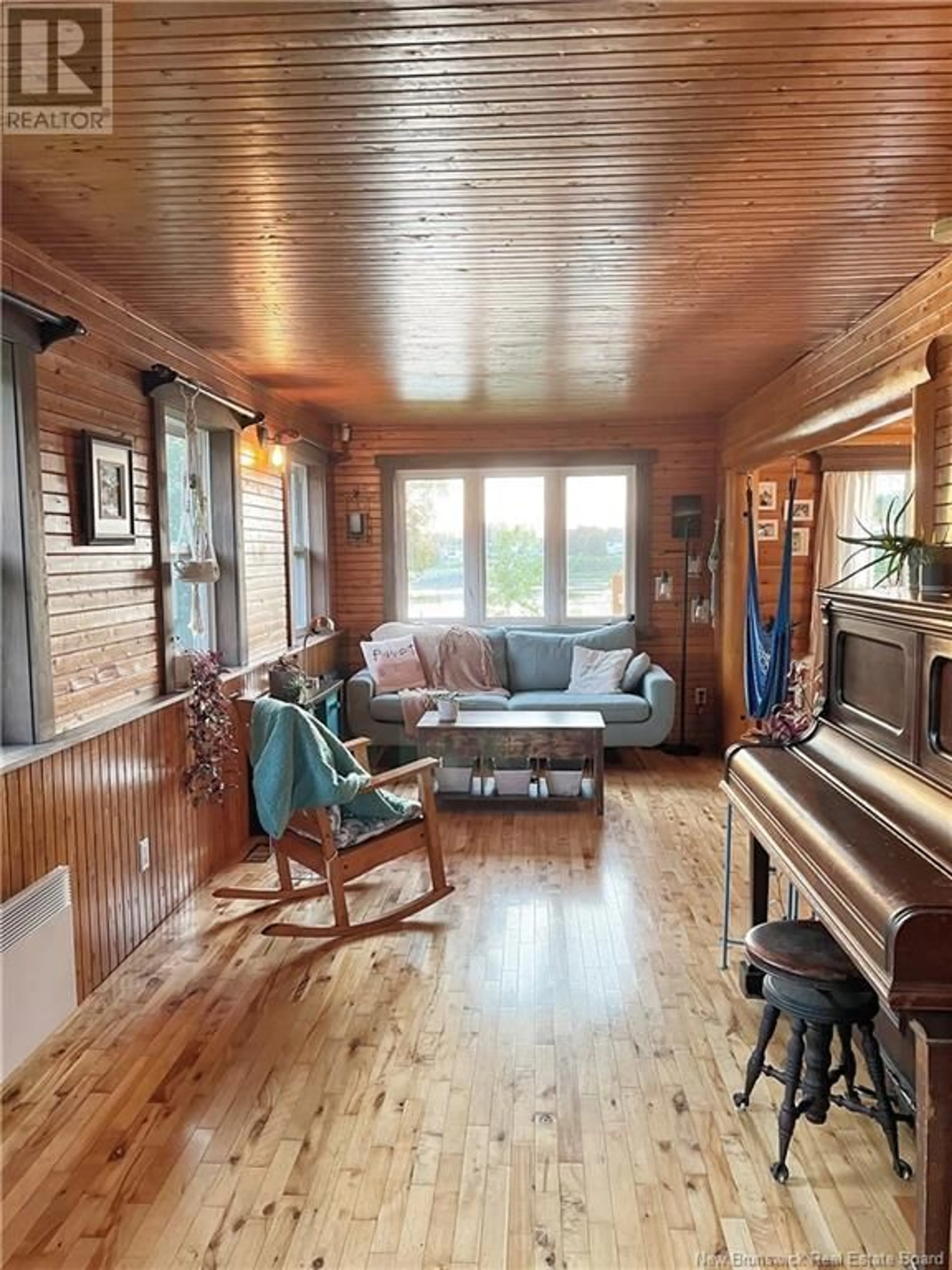 Living room with furniture, wood/laminate floor for 17 CHEM. PONT ODILON, Petit-Tracadie New Brunswick E1X3P8