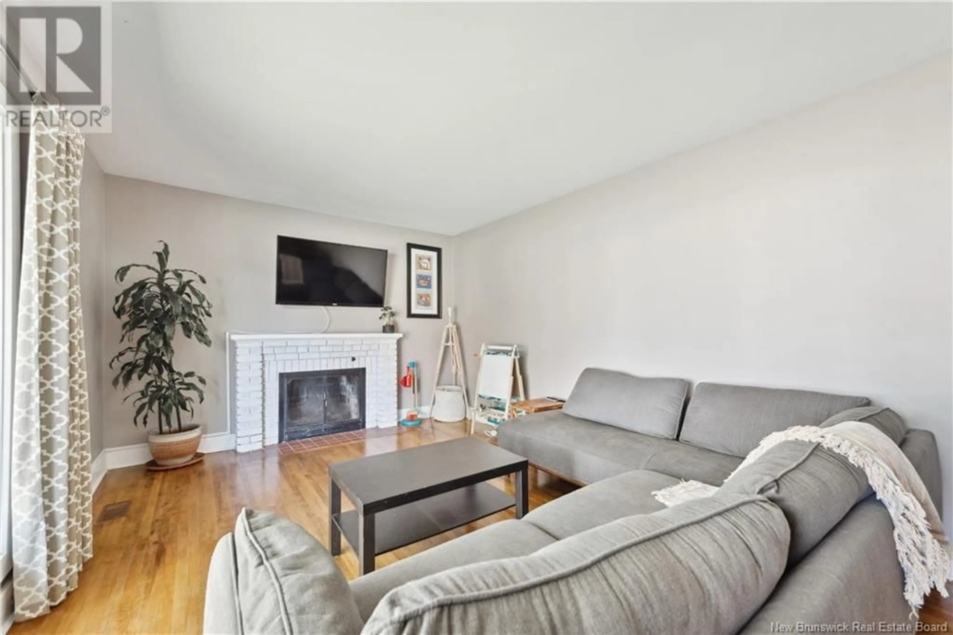 Living room with furniture, wood/laminate floor for 62 BESSBOROUGH AVENUE, Moncton New Brunswick E1E1P5