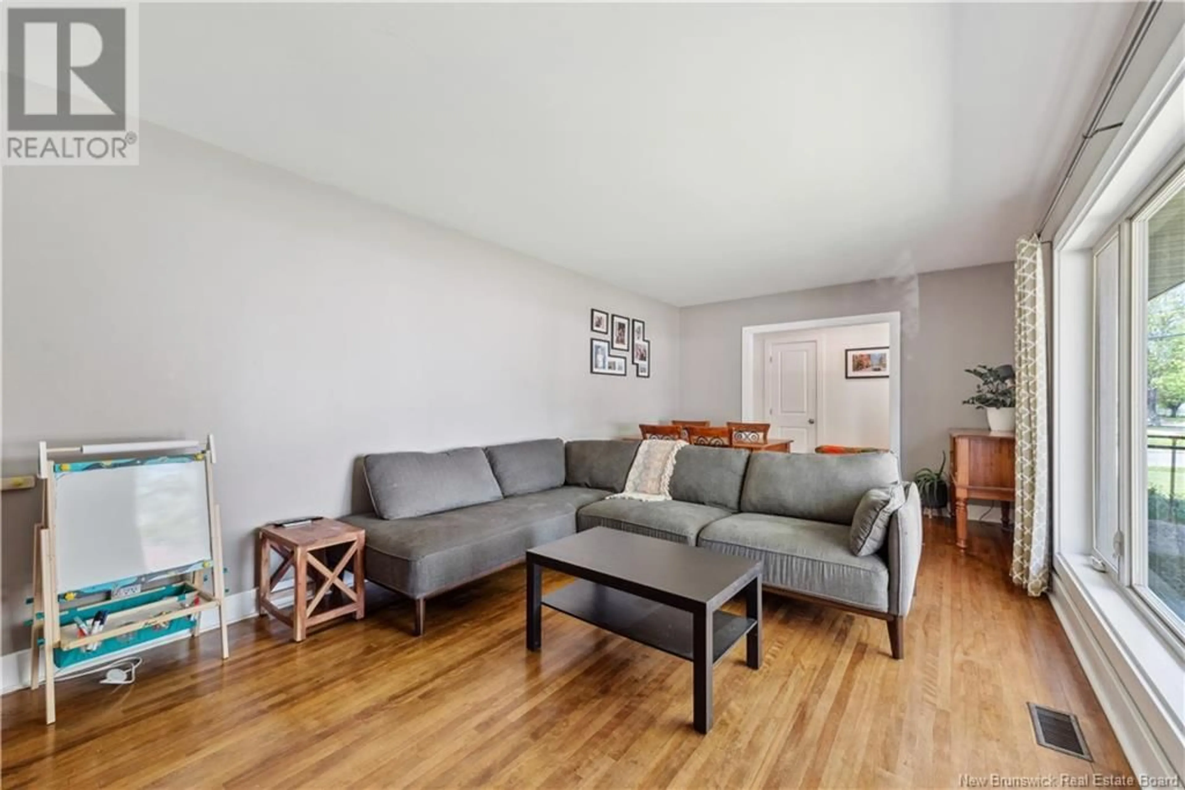 Living room with furniture, wood/laminate floor for 62 BESSBOROUGH AVENUE, Moncton New Brunswick E1E1P5