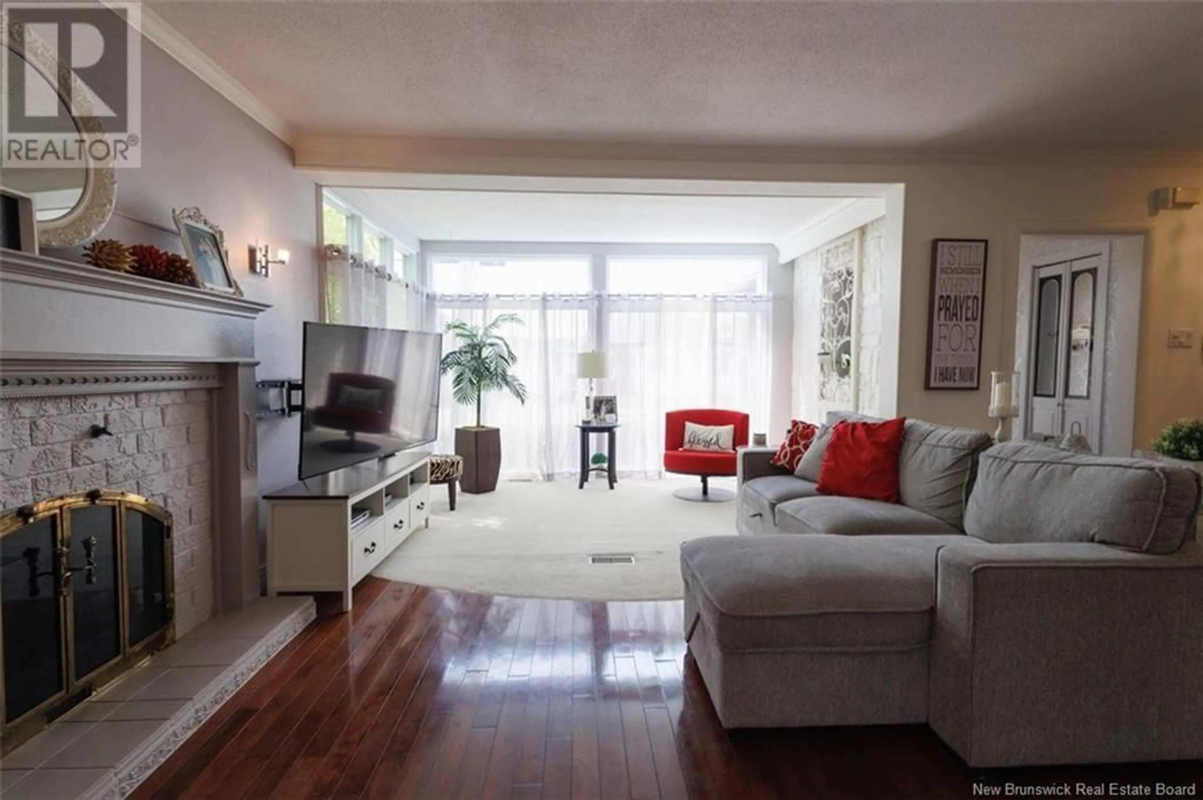 Living room with furniture, wood/laminate floor for 53 34E AVENUE, Edmundston New Brunswick E3V2T3