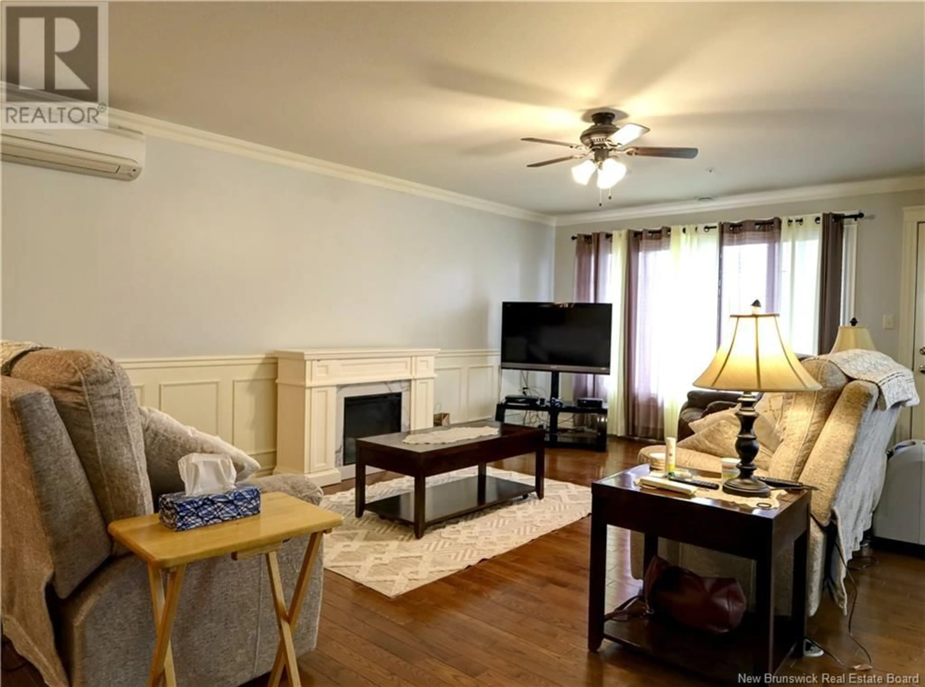 Living room with furniture, wood/laminate floor for 216 - 99 VALCOUR DRIVE, Fredericton New Brunswick E3C0J2