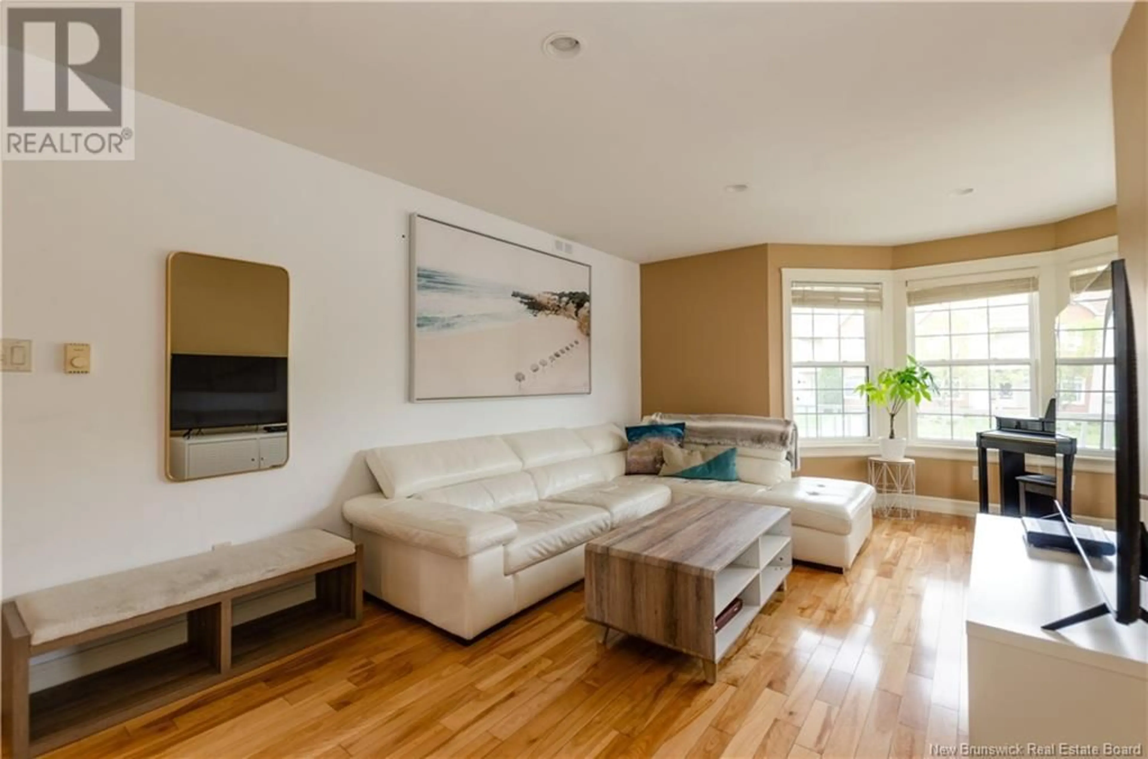 Living room with furniture, wood/laminate floor for 136 ROYAL OAKS BOULEVARD, Moncton New Brunswick E1H3S4