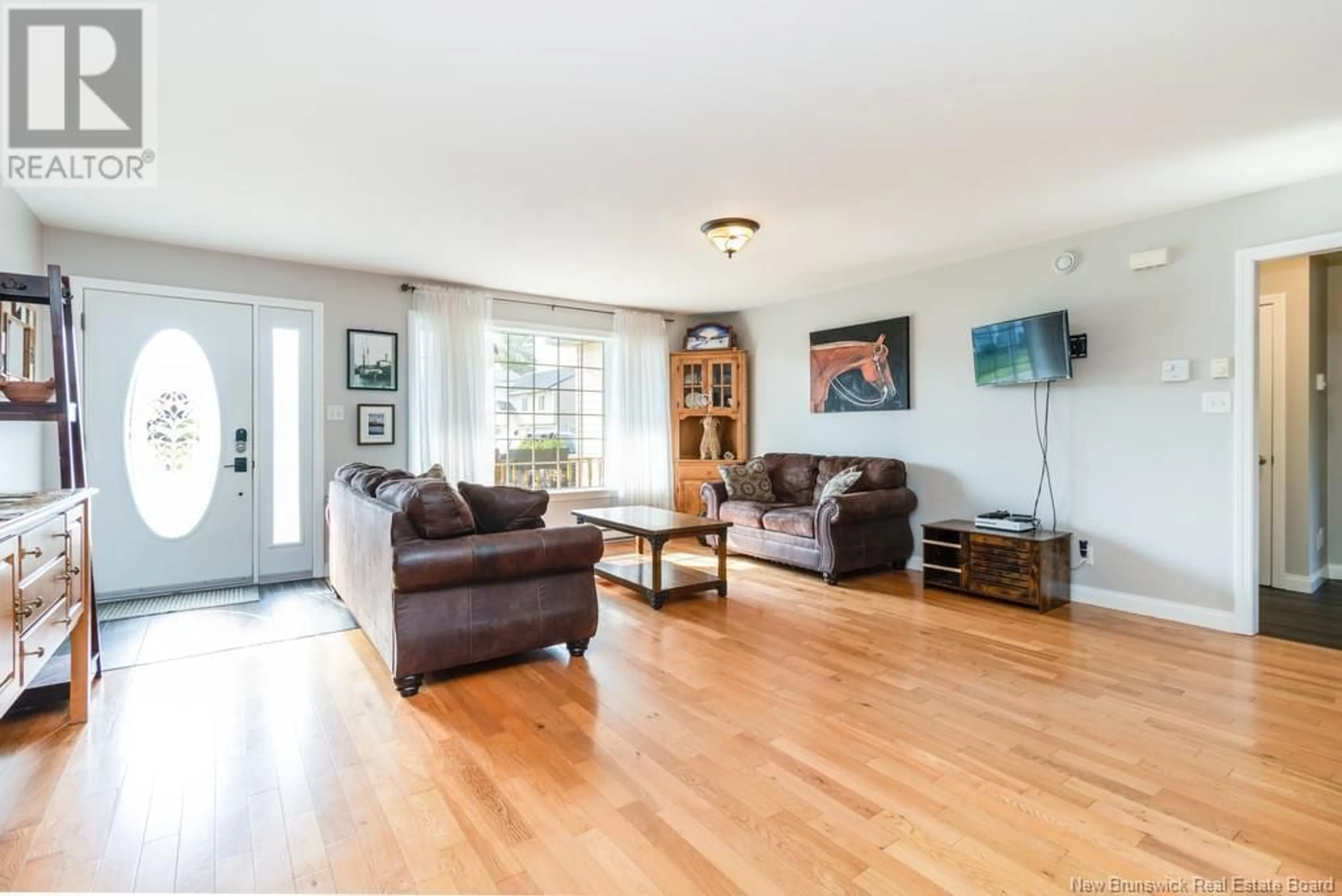 Living room with furniture, wood/laminate floor for 12 DAWSON DRIVE, Oromocto New Brunswick E2V4S7
