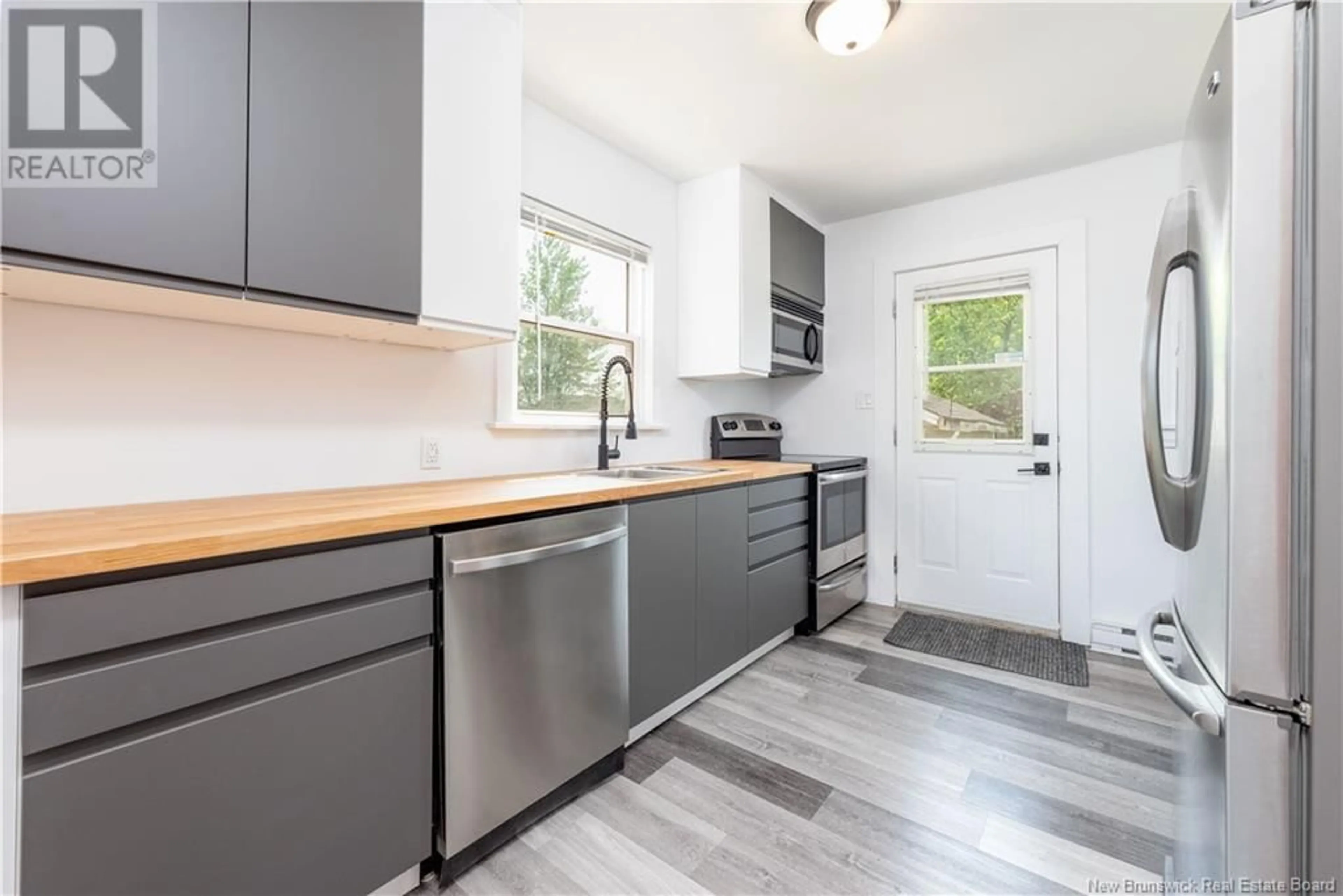 Open concept kitchen, wood/laminate floor for 26 LESLIE STREET, Moncton New Brunswick E1C6M2