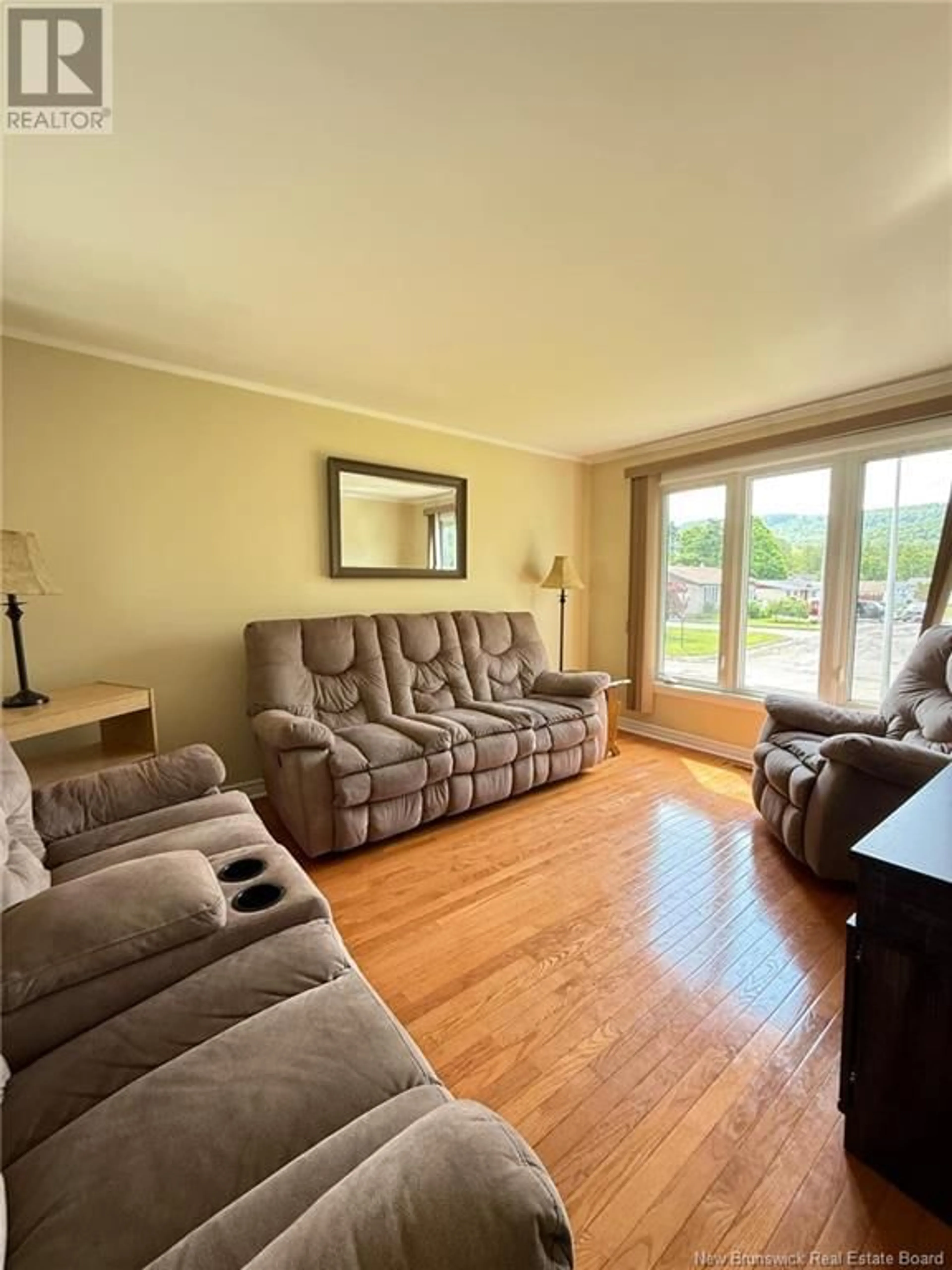 Living room with furniture, wood/laminate floor for 4 ESQUADICH CIRCLE, Campbellton New Brunswick E3N2E6
