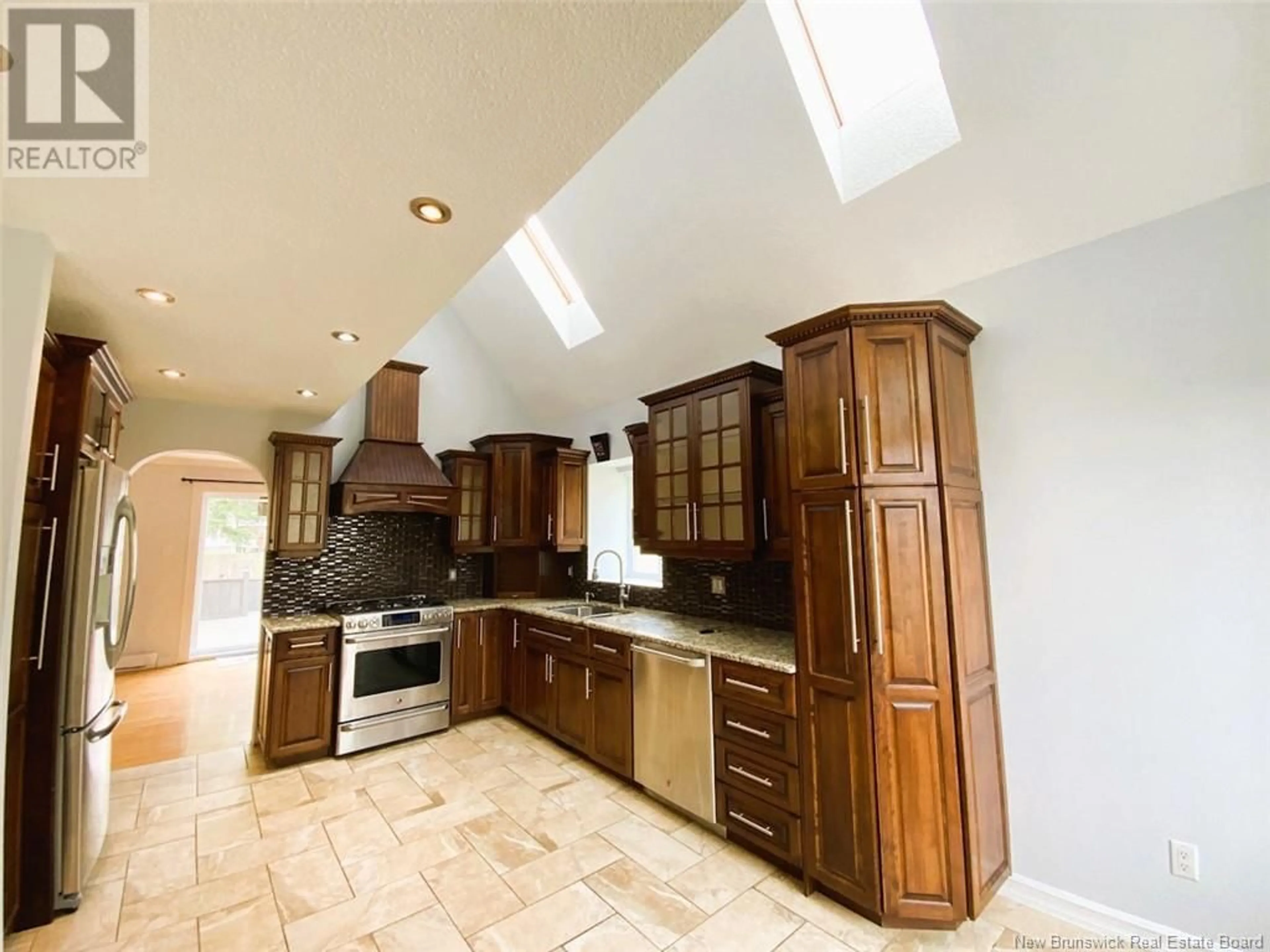 Open concept kitchen, ceramic/tile floor for 42 THIBAUDEAU AVENUE, Edmundston New Brunswick E3V4Z1