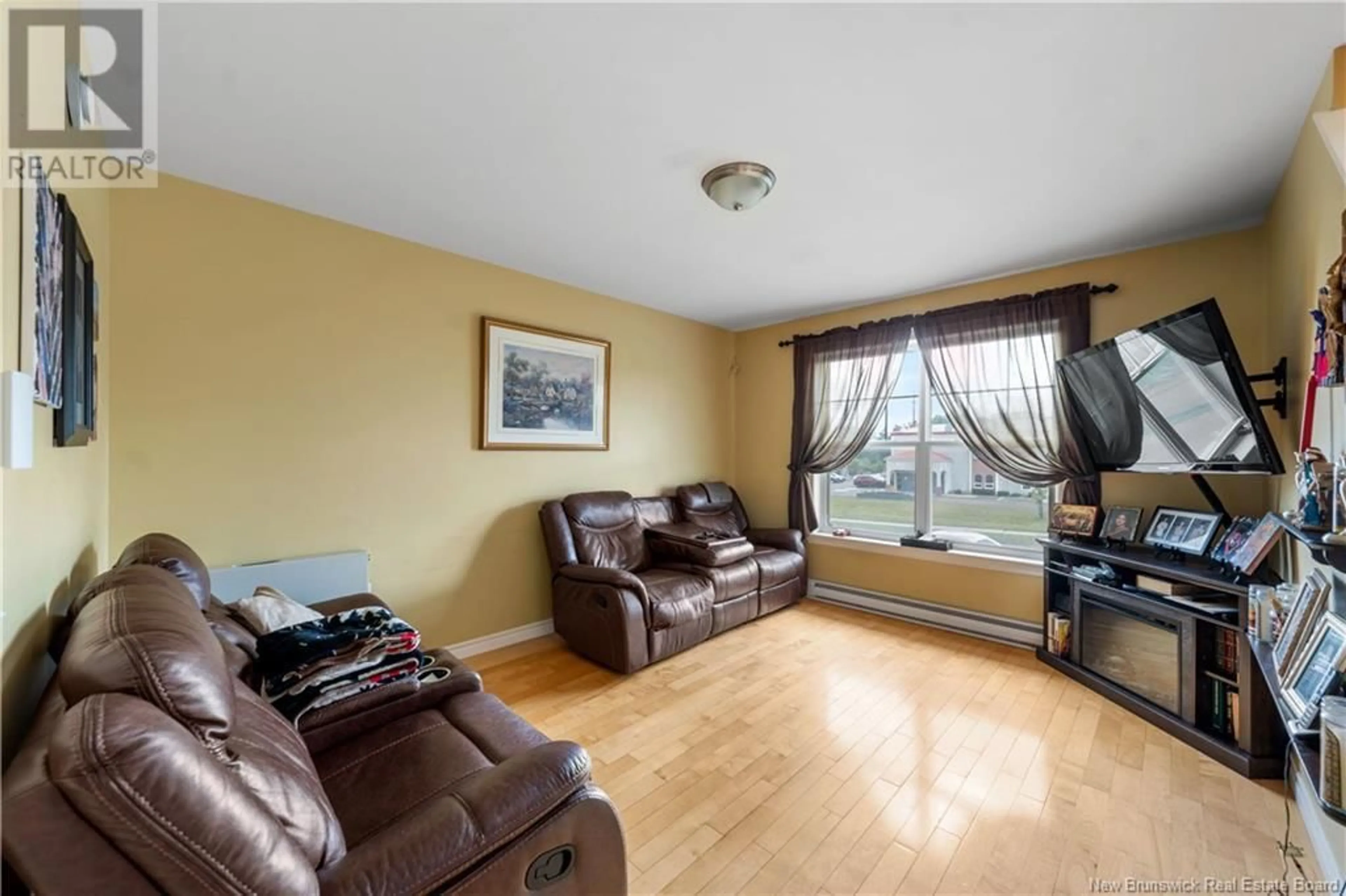 Living room with furniture, wood/laminate floor for 39 SUNSHINE DRIVE, Moncton New Brunswick E1G2A3