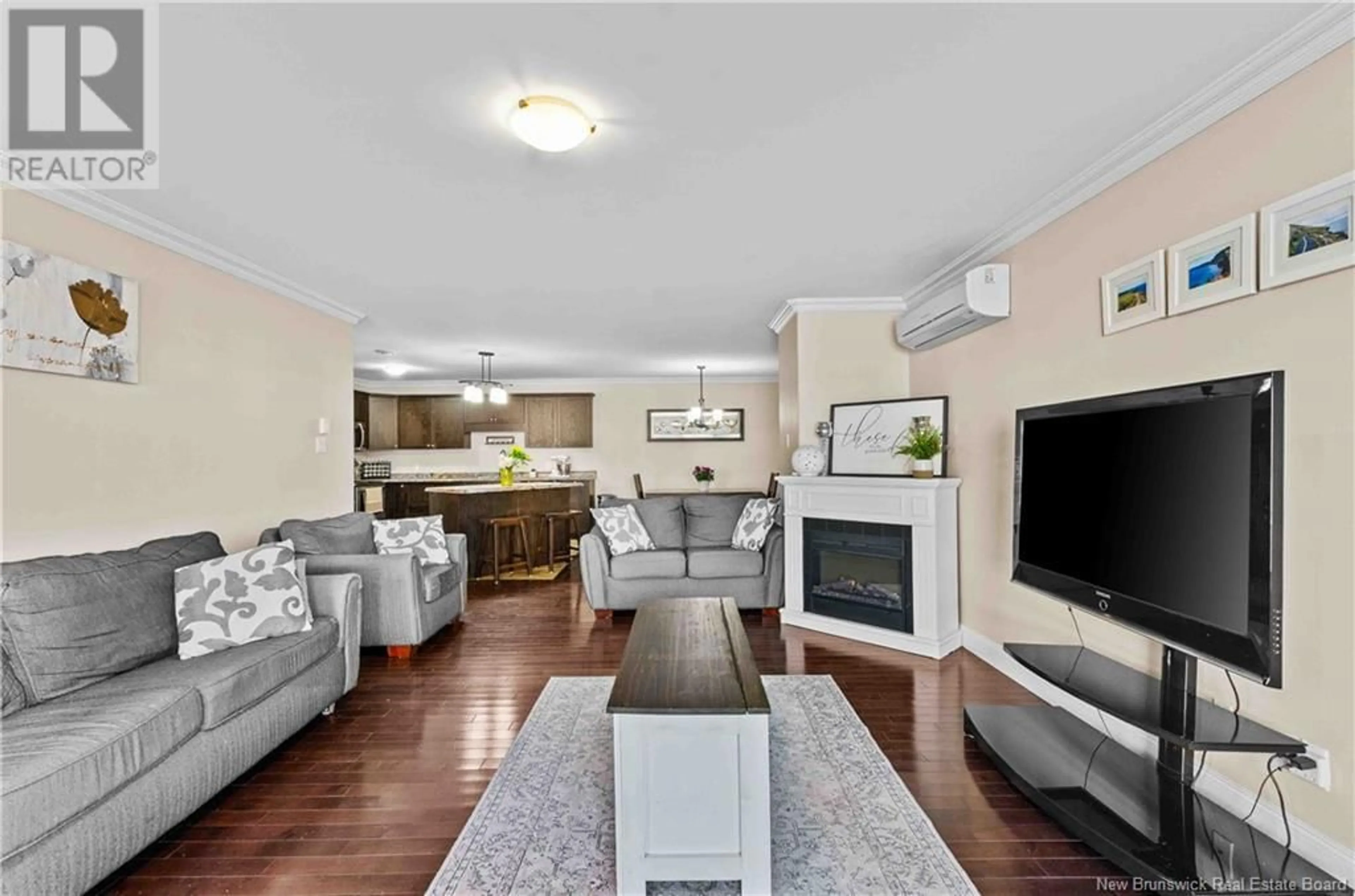 Living room with furniture, wood/laminate floor for 131 - 29 SUNNY BRAE DRIVE, Fredericton New Brunswick E3A5M2