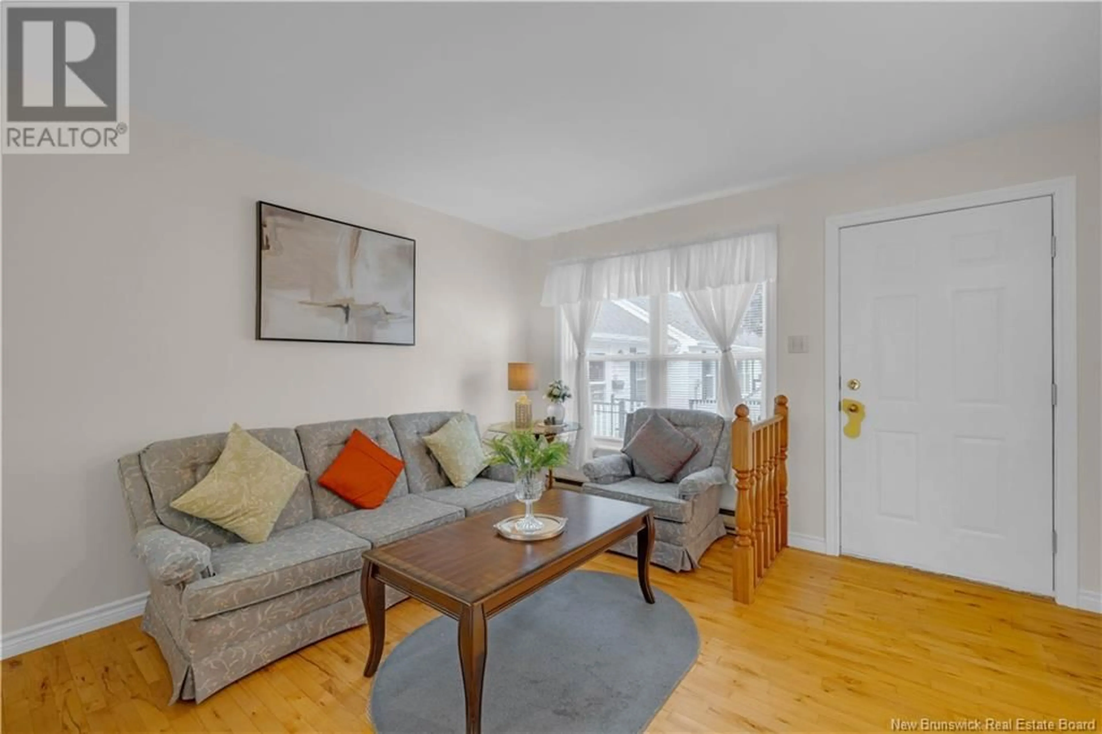 Living room with furniture, wood/laminate floor for 14 HERITAGE GARDENS, Saint John New Brunswick E2M5R7