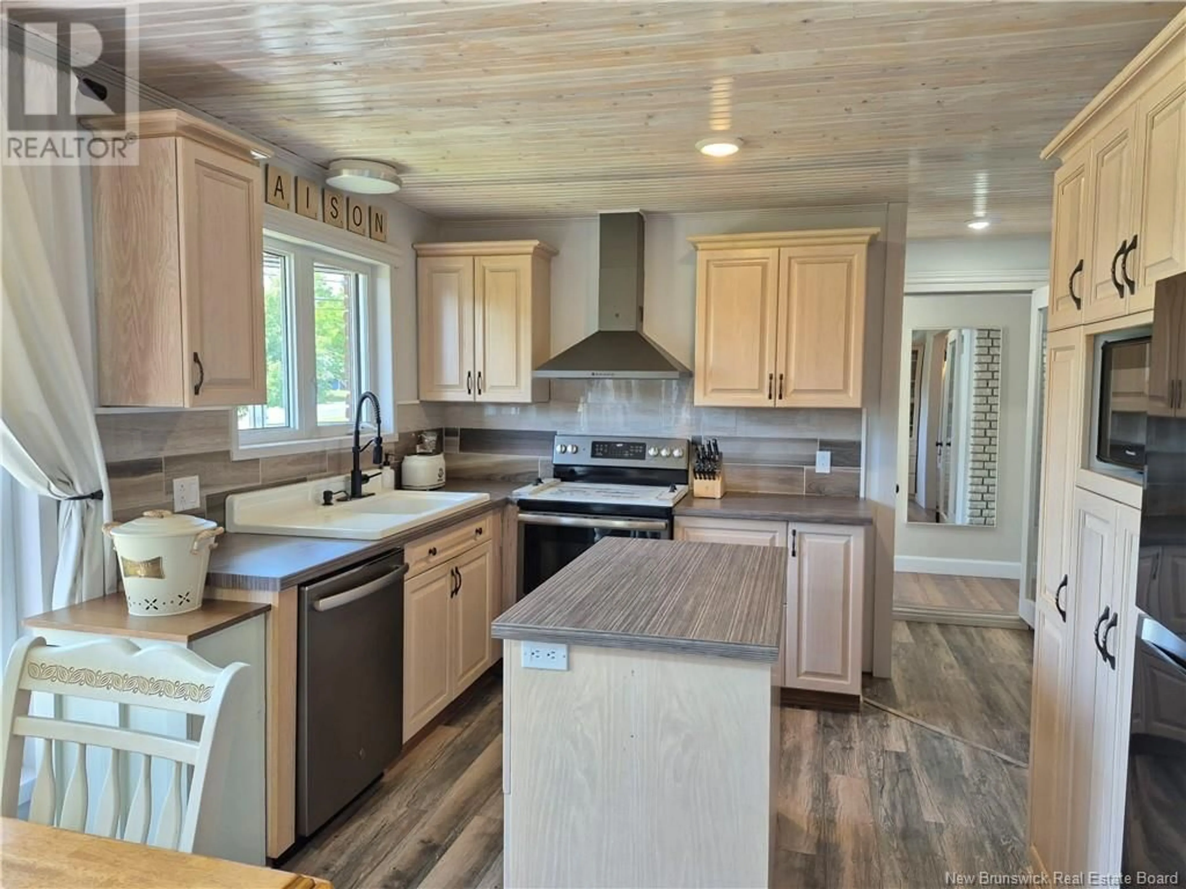 Open concept kitchen, wood/laminate floor for 54 CH TREMBLAY, Petit-Rocher-Sud New Brunswick E8J1A5