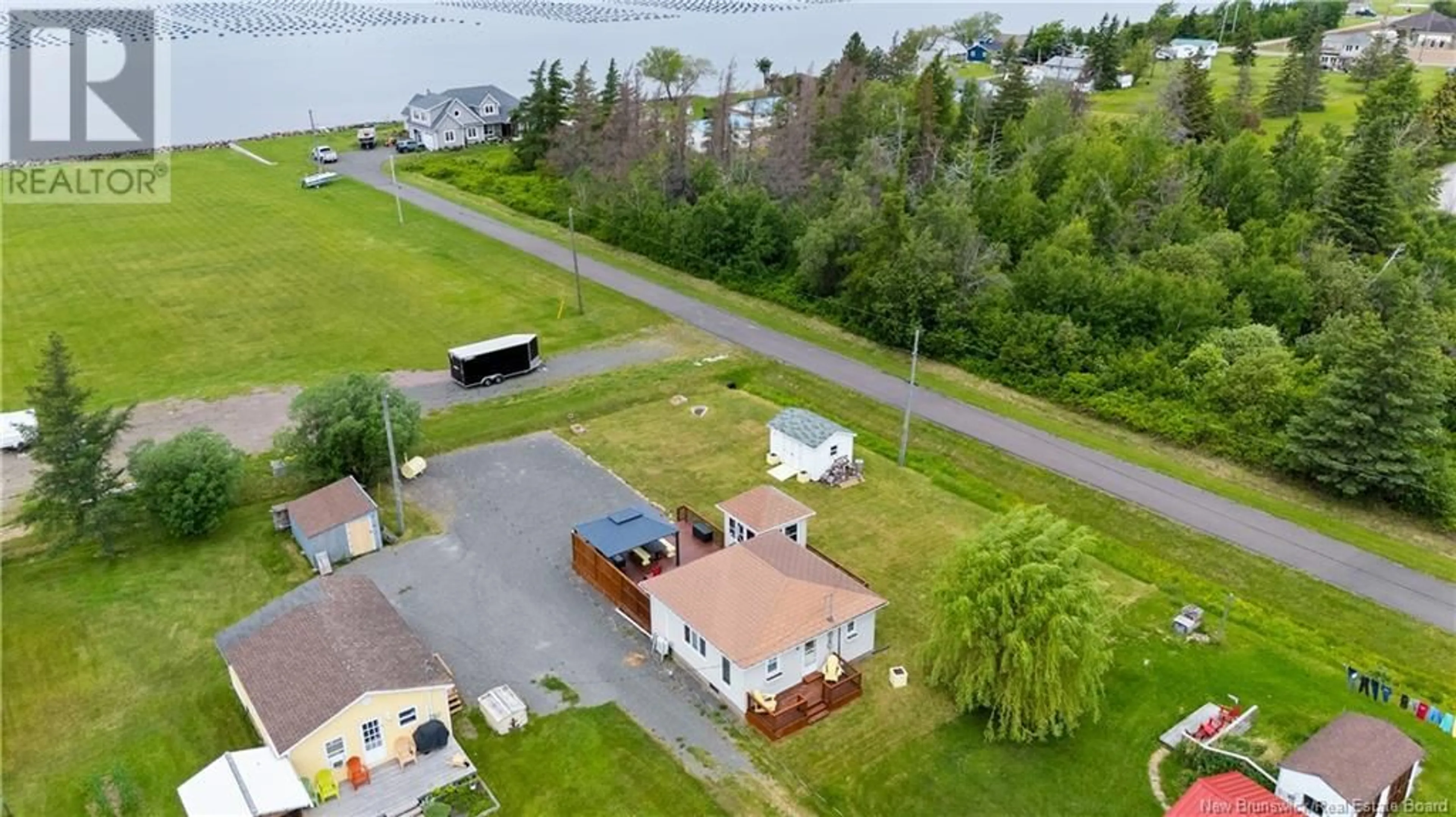A pic from outside/outdoor area/front of a property/back of a property/a pic from drone, water/lake/river/ocean view for 32 ALLEE DES COPAINS, Grande-Digue New Brunswick E4R5N7