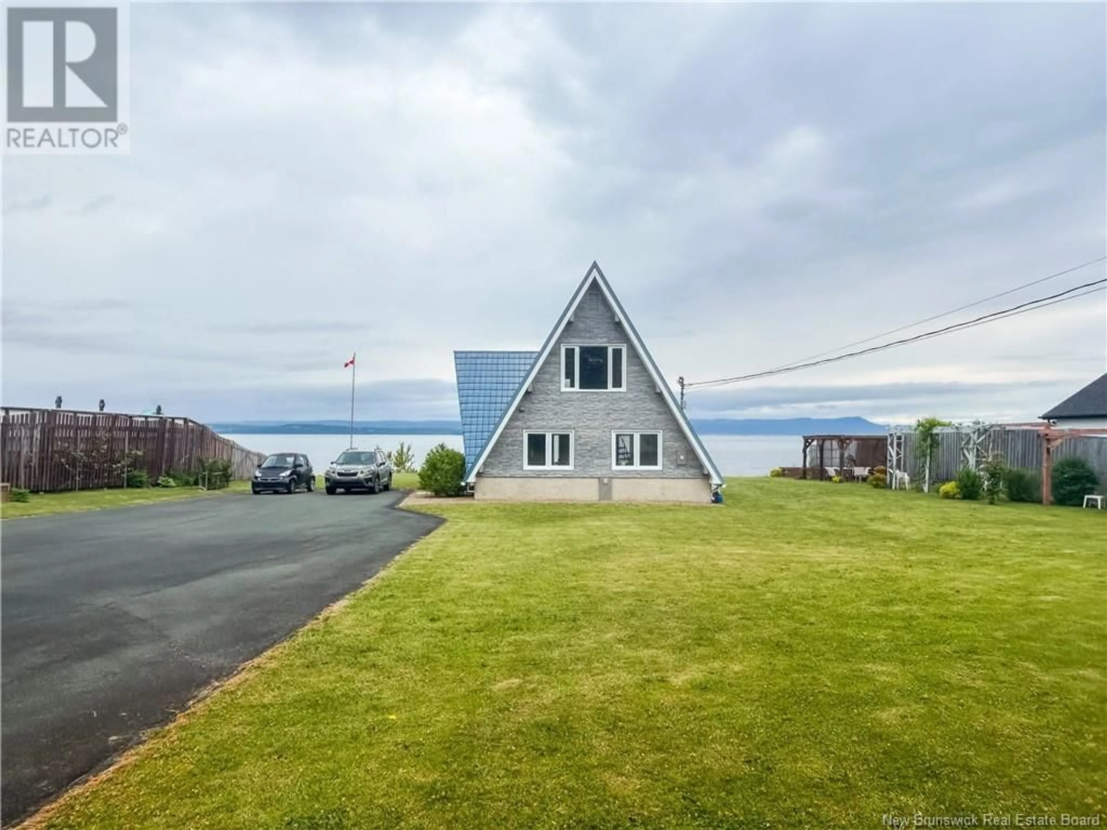A pic from outside/outdoor area/front of a property/back of a property/a pic from drone, water/lake/river/ocean view for 11 21 LANE, Charlo New Brunswick E8E2V3