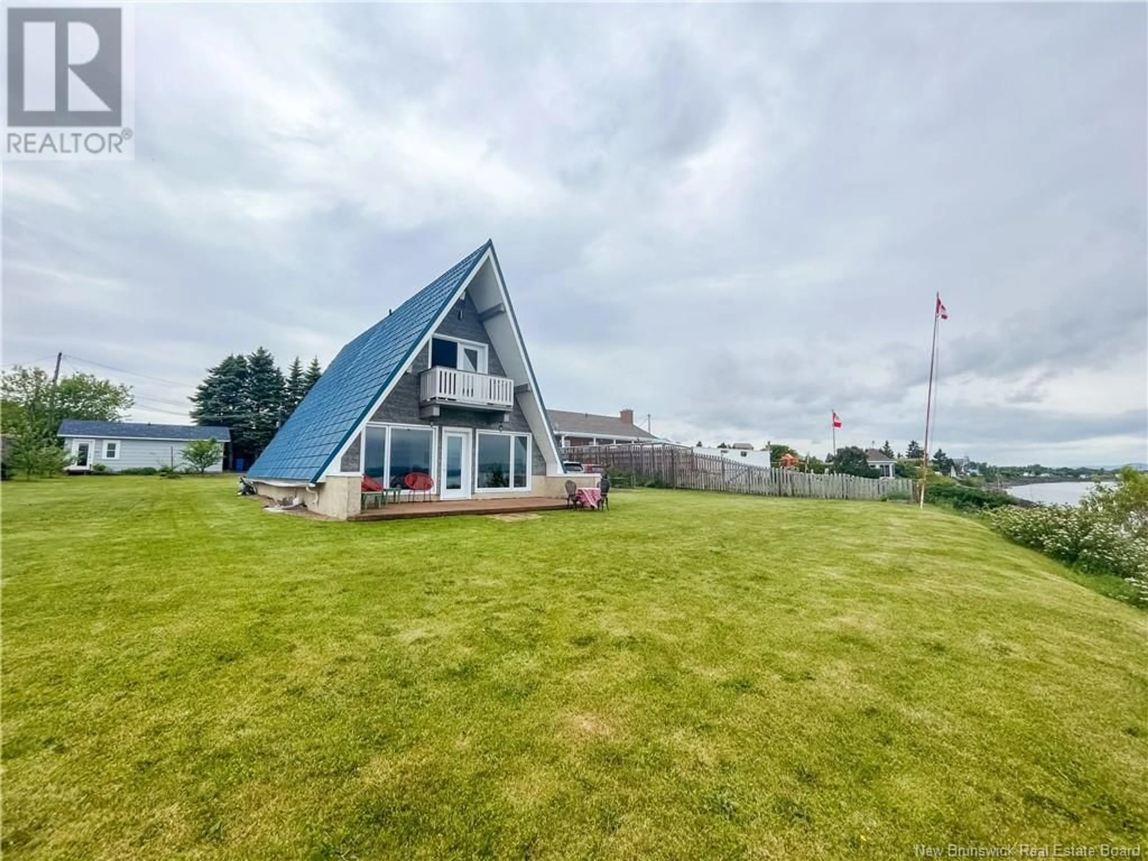 A pic from outside/outdoor area/front of a property/back of a property/a pic from drone, water/lake/river/ocean view for 11 21 LANE, Charlo New Brunswick E8E2V3