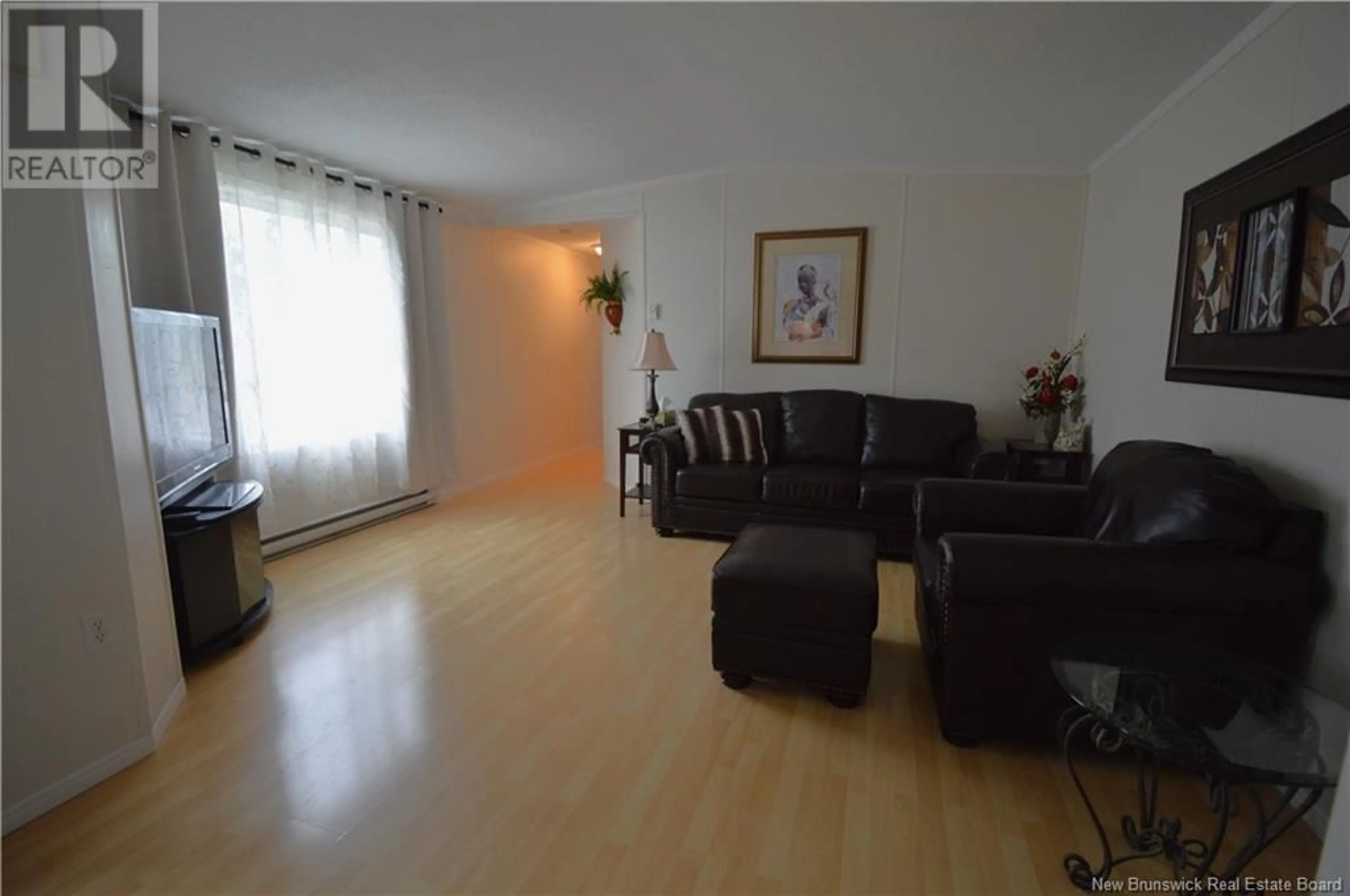 Living room with furniture, wood/laminate floor for 625 CHAMPLAIN STREET, Shediac New Brunswick E4P9C8
