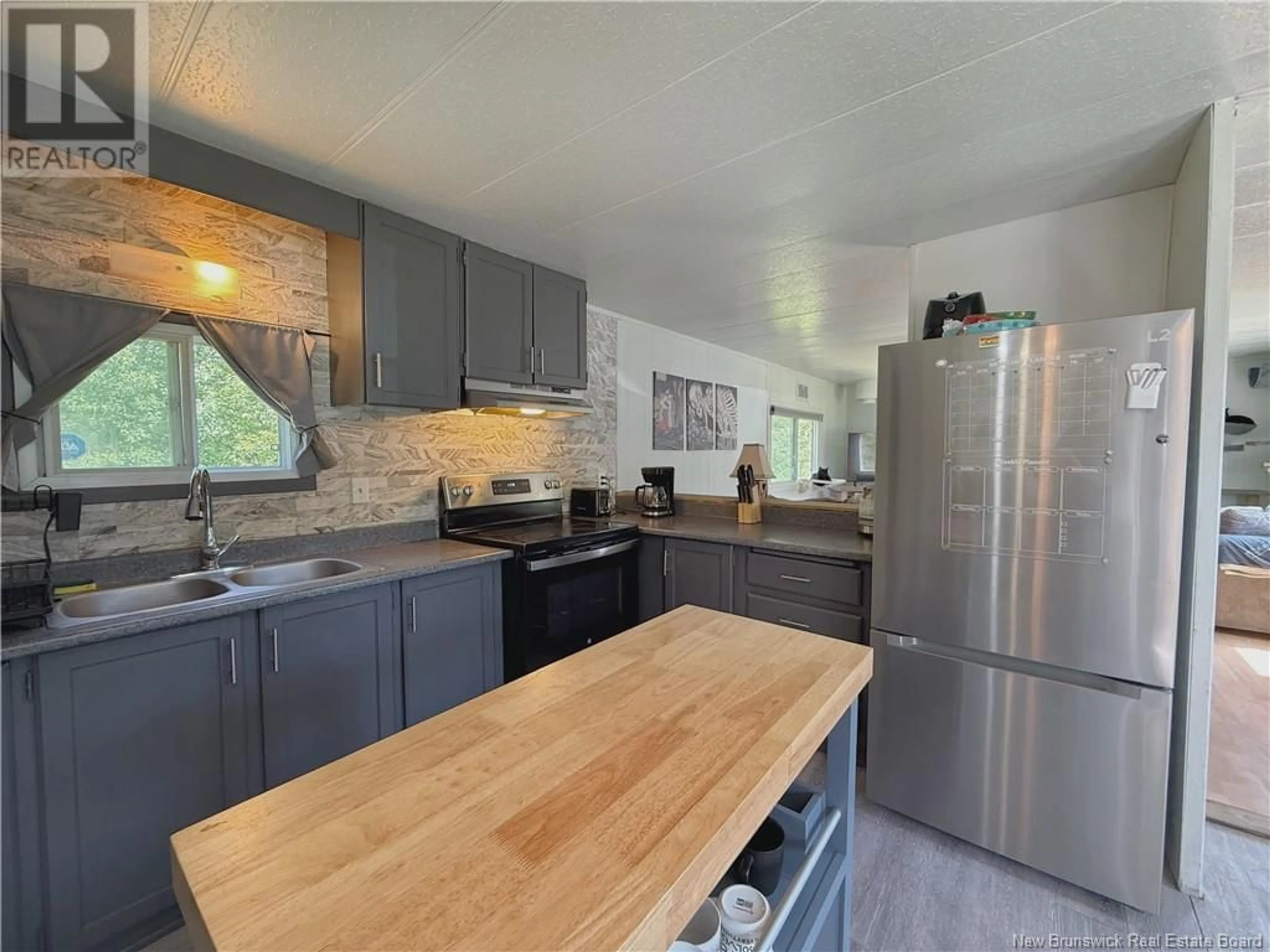 Open concept kitchen, wood/laminate floor for 59 KELLY ROAD, Coles Island New Brunswick E4C2W5
